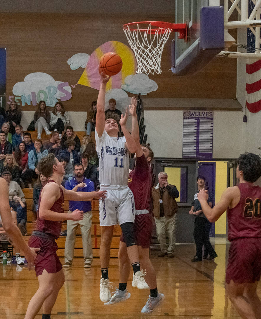 Sequim sophomore Charlie Grider drives through the Kingston defense for a basket in the Wolves’ 70-56 win on Jan. 3.