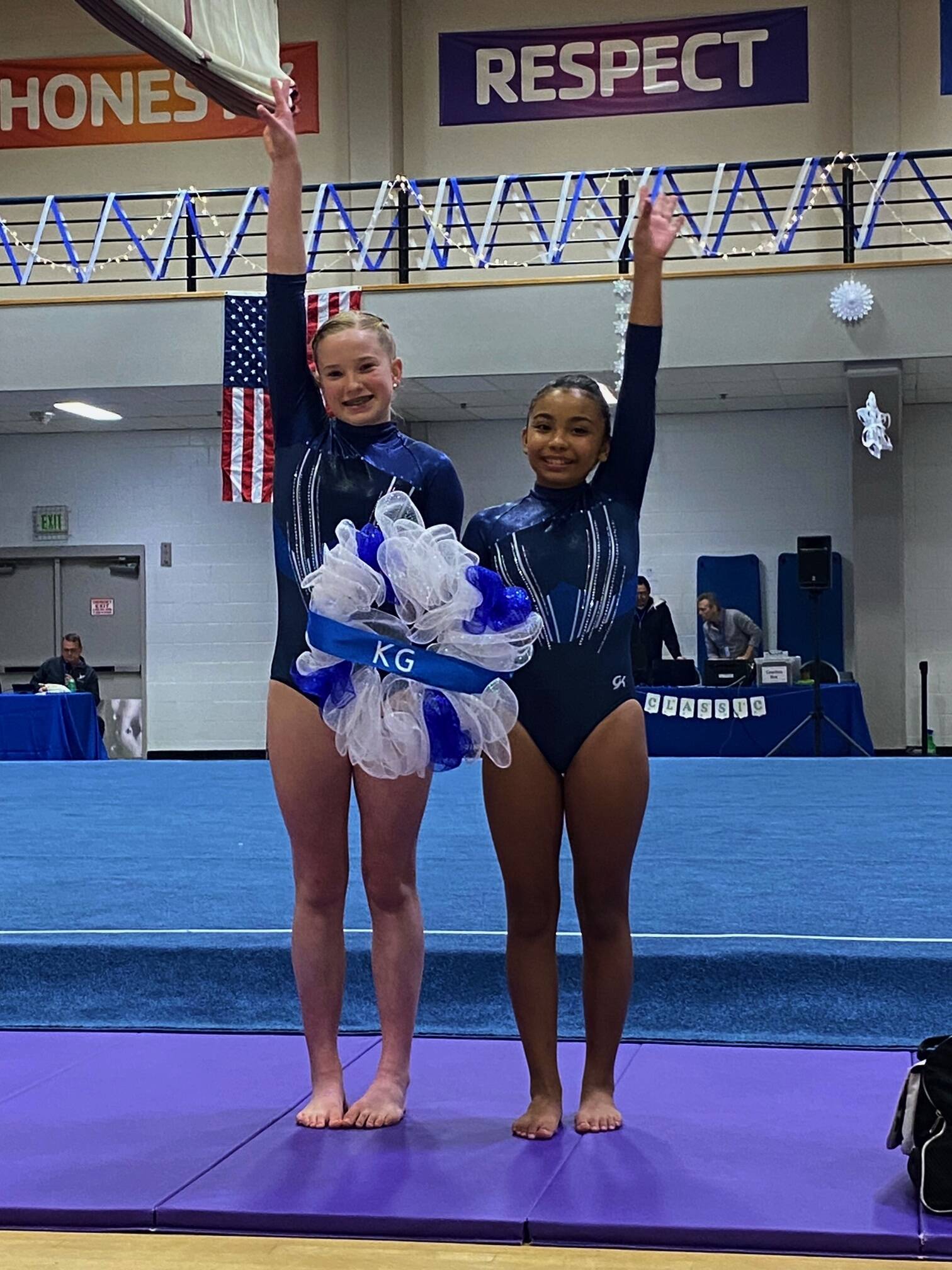 Submitted photo / Klahhane Gymnastics Platinum Team gymnasts Mariah Traband, left, and Kira Hartman cap their efforts in the Snowball Classic in Lakewood on Jan. 7.