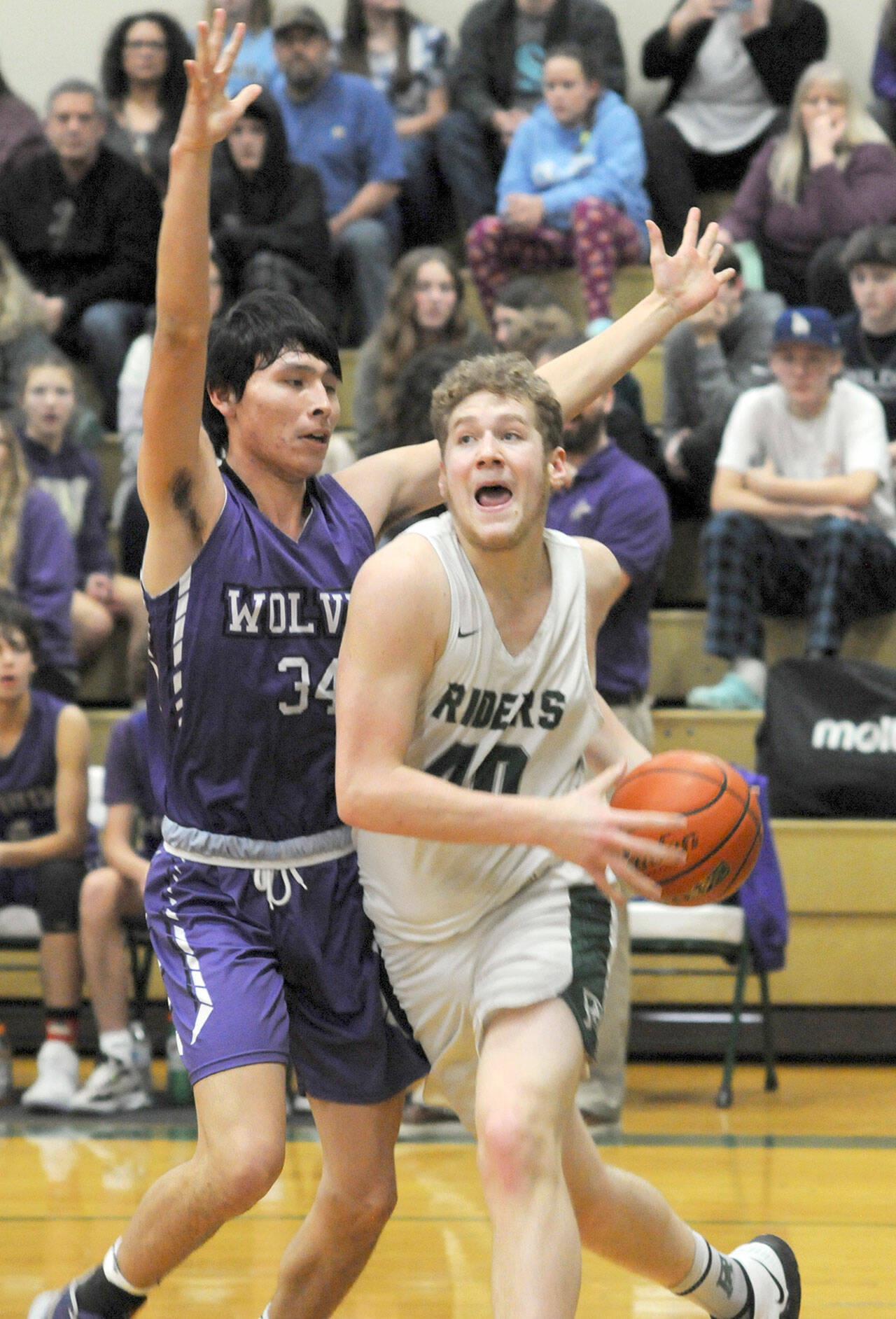 Photos by Keith Thorpe/Olympic Peninsula News Group
Port Angeles’ Isaiah Shamp, right, pushes past Sequim’s Isaiah Moore on the way to the lane on Jan. 10 in Port Angeles.