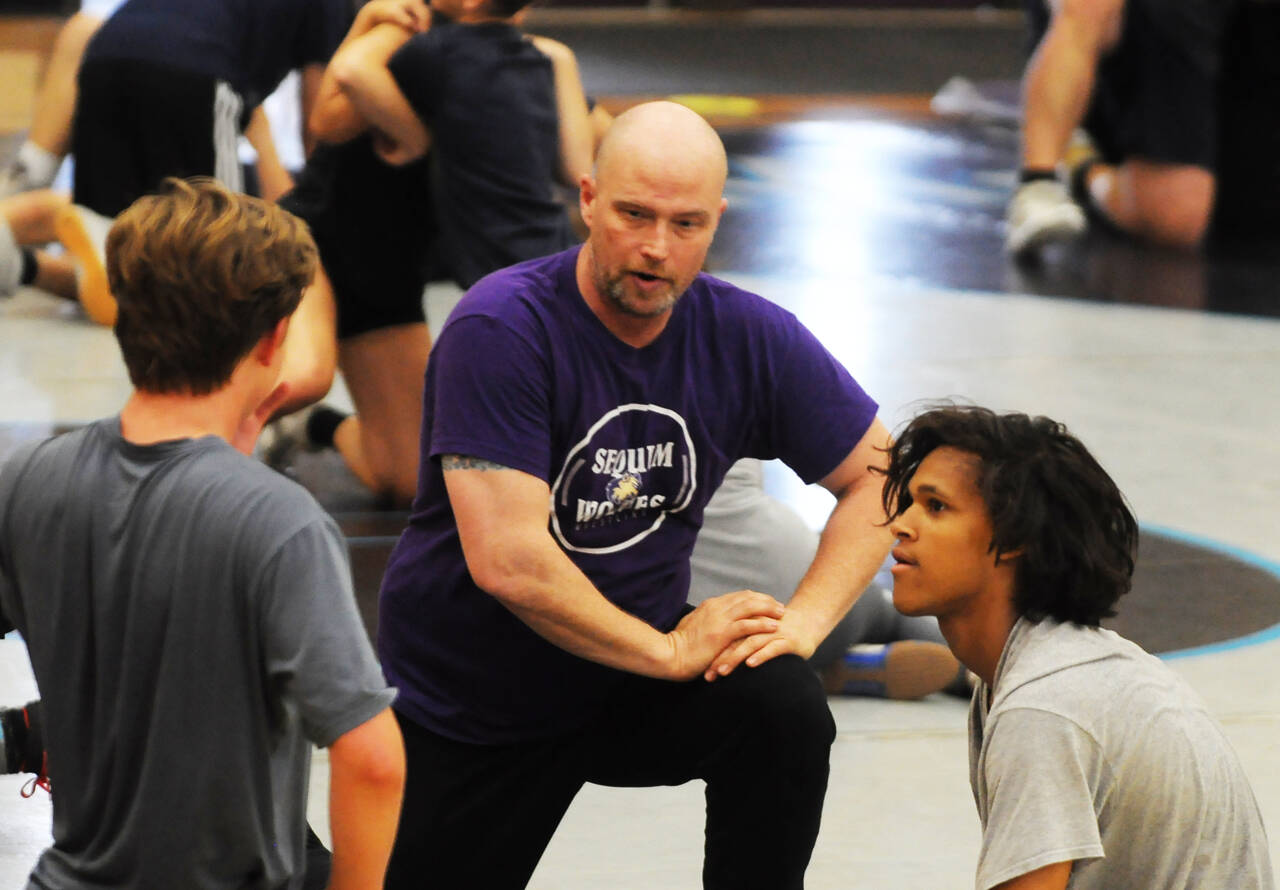 Sequim Gazette file photo by Michael Dashiell 
Sequim High wrestling coach Chad Cate works with campers at a camp in Sequim in July 2022.