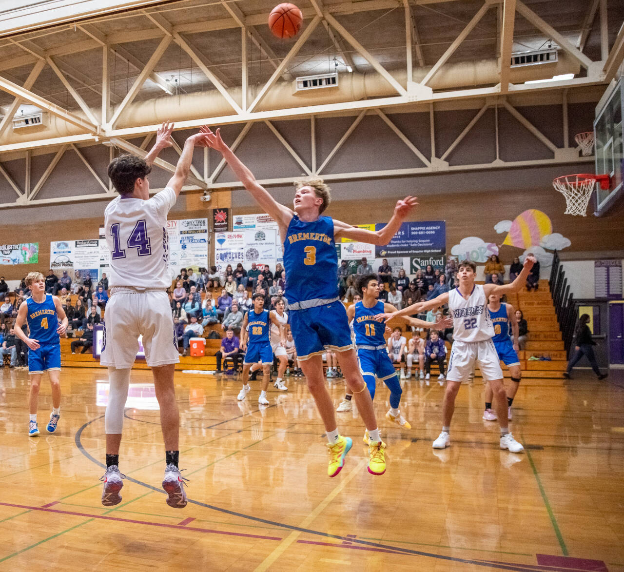 Sequim Gazette photo by Emily Matthiessen
Sequim’s Vince Carrizosa, left, launches a 3-pointer over Bremerton’s Giovanni Lowe in the Wolves’ 60-49 win over the visiting Knights on Jan. 17. Carrizosa led Sequim with 14 points, sinking three 3-pointers in the third quarter.