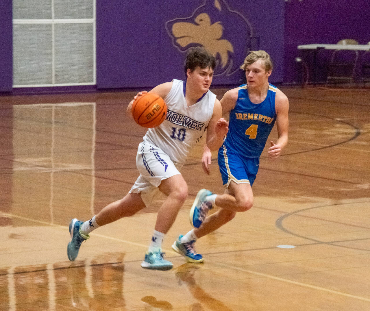 Sequim Gazette photo by Emily Matthiessen / Sequim’s Keenan Green, left, drives by Bremerton’s Trenton Bulmer in SHS’s Olympic League win over the Knights on Jan. 17.