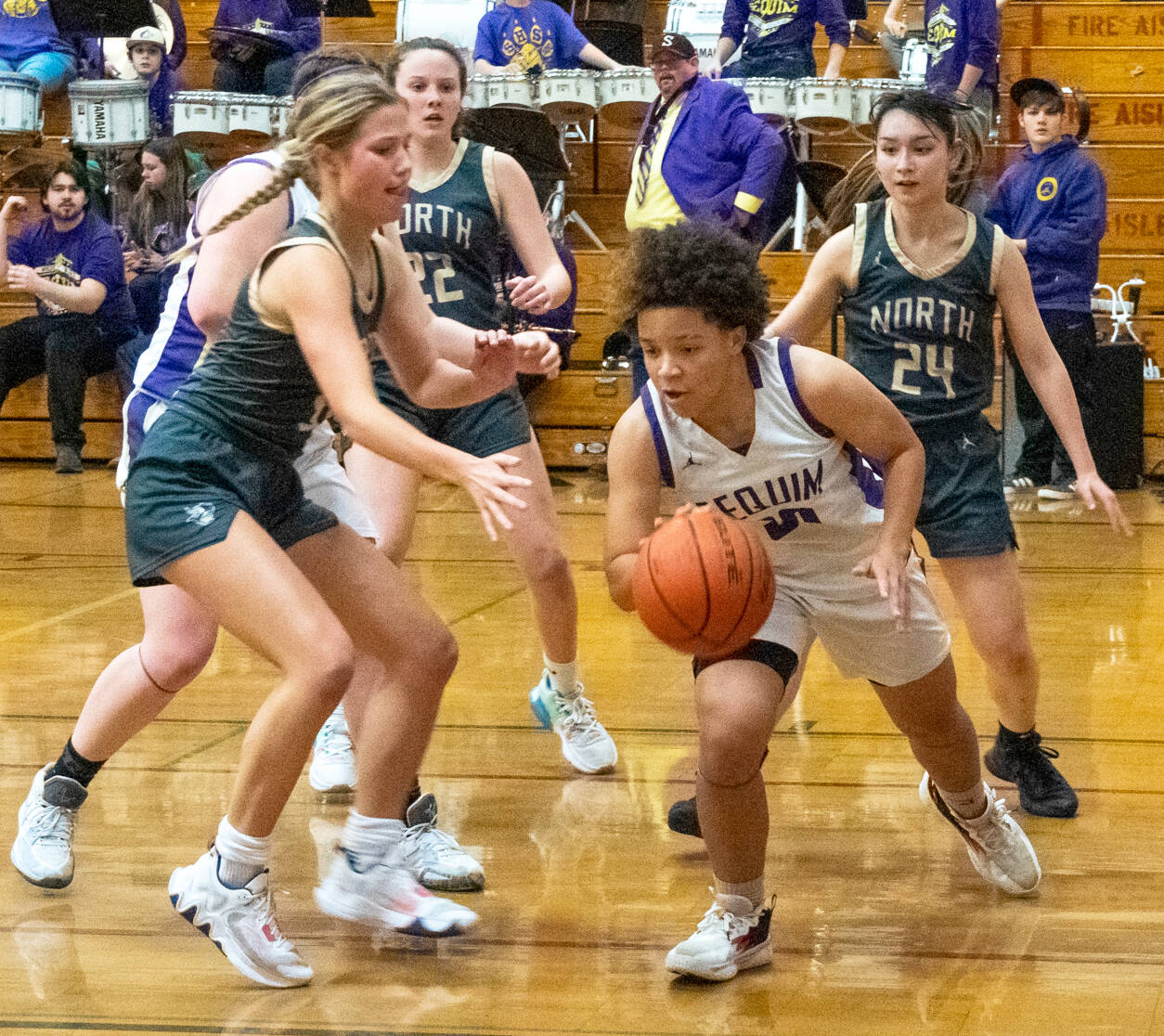 Sequim Gazette photo by Emily Matthiessen / Sequim guard Bobbi Mixon, right, dribbles out of trouble in the Wolves’ 64-49 win over North Kitsap on Jan. 19.