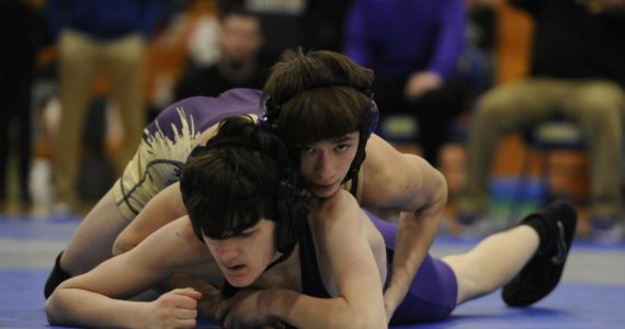 Sequim’s Cayden Beauregard, top right, takes on North Kitsap’s Nolan Hancock at a sub-district tournament in Bremerton on Feb. 4. Beauregard won the match by technical fall (18-3) and took first place overall at 106 pounds.