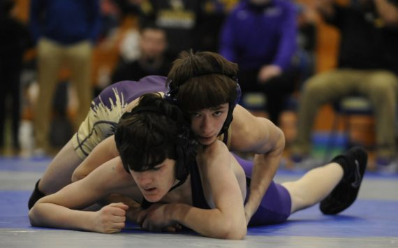Sequim’s Cayden Beauregard, top right, takes on North Kitsap’s Nolan Hancock at a sub-district tournament in Bremerton on Feb. 4. Beauregard won the match by technical fall (18-3) and took first place overall at 106 pounds.