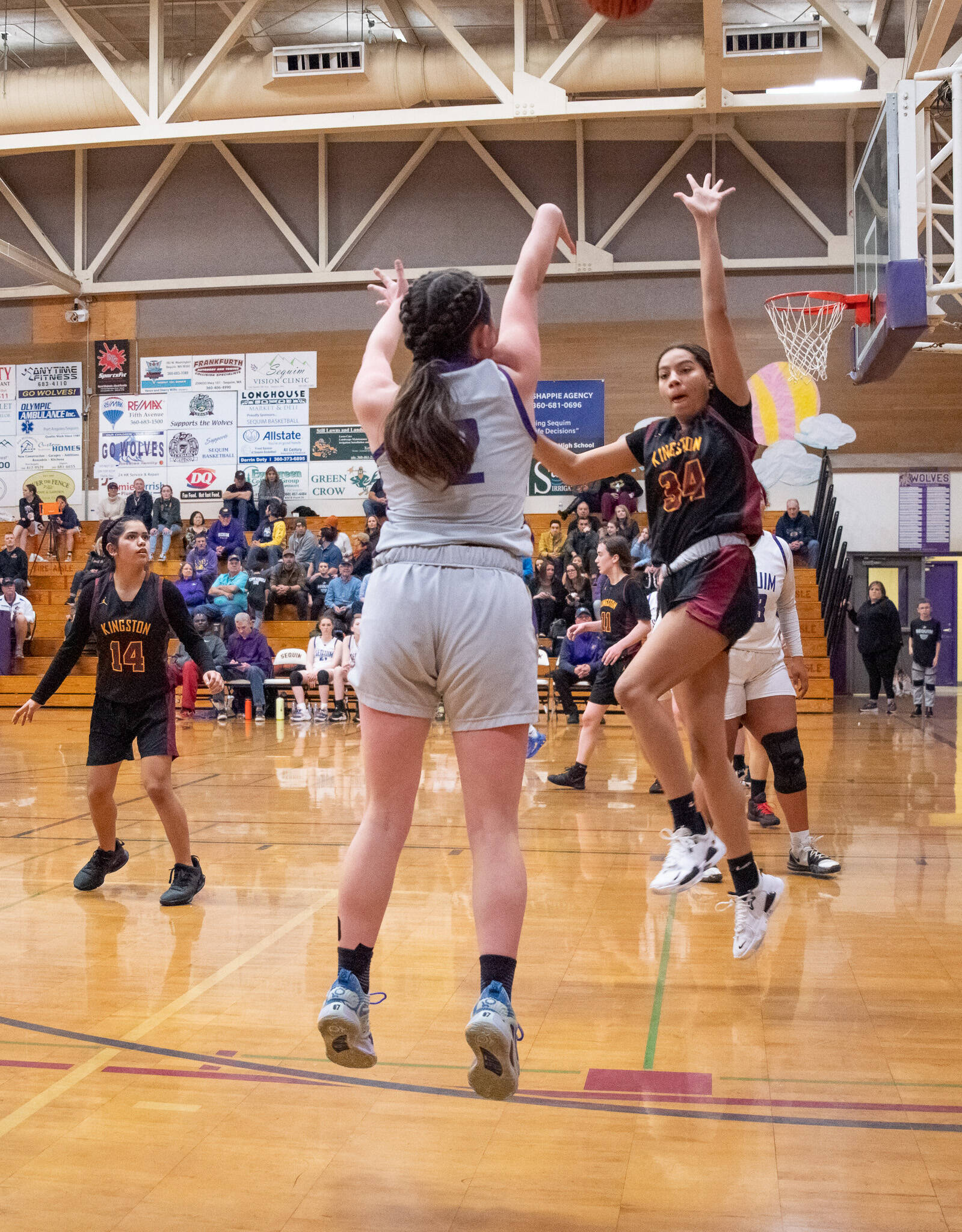 Sequim’s Hannah Bates (2) puts up a 3-point shot over a Kingston defender in the Wolves’ 72-28 home win on Jan. 27. Bates had nine assists in the victory.