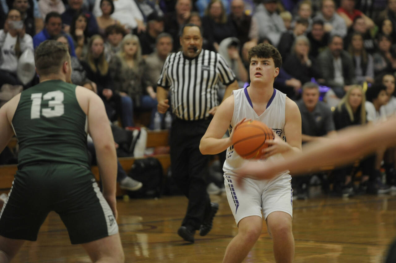 Sequim’s Keenan Green, right, lines up a 3-pointer in the first half of the Wolves’ 60-57 win over Port Angeles on Feb. 2. Green led the team with 13 points.