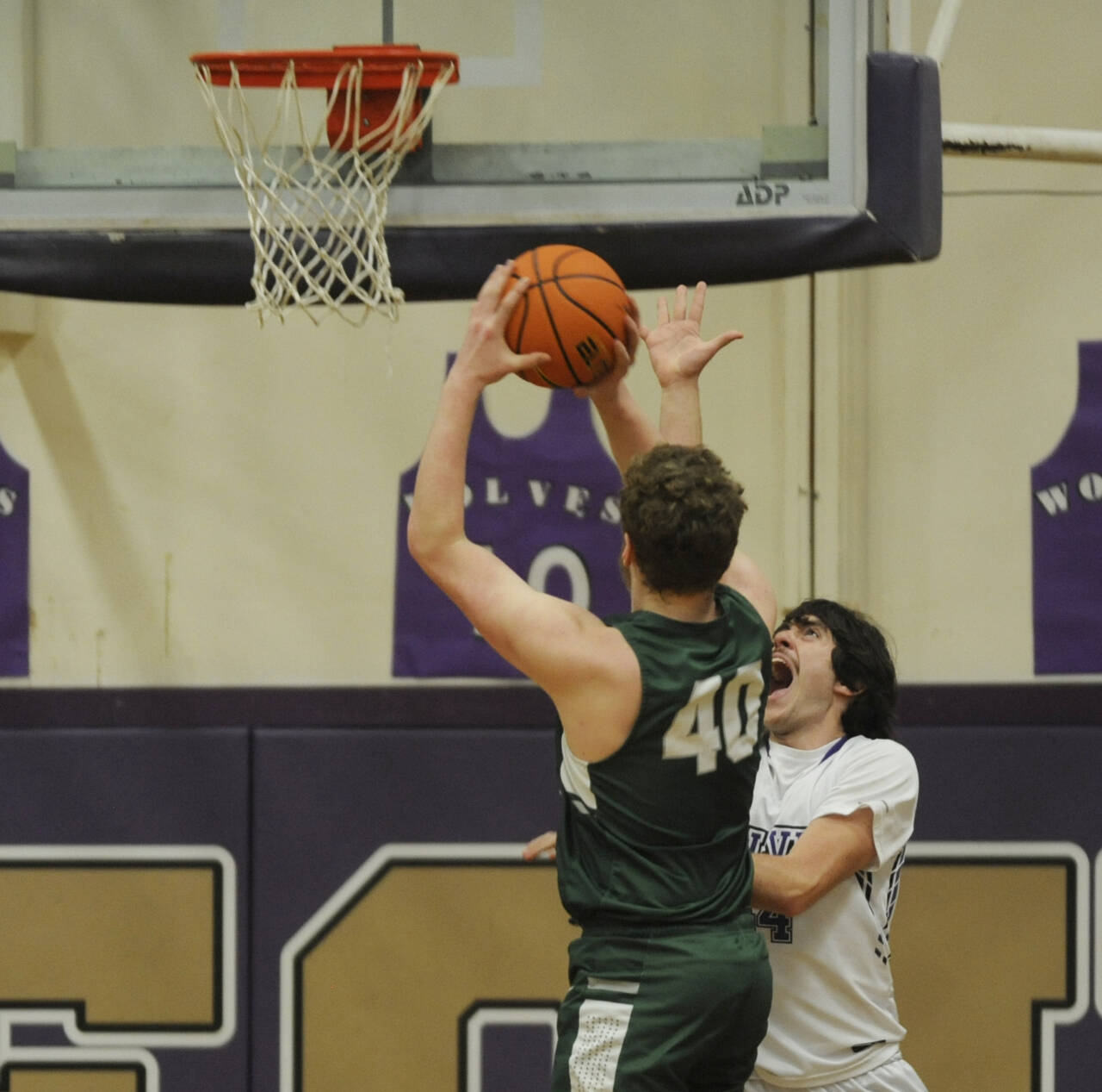 Sequim Gazette photo by Michael Dashiell / Sequim’s Cole Smithson, right, tries to defend the basket as Port Angeles’ Isaiah Shamp looks to score in the first half of the Wolves’ Olympic League win on Feb. 2.