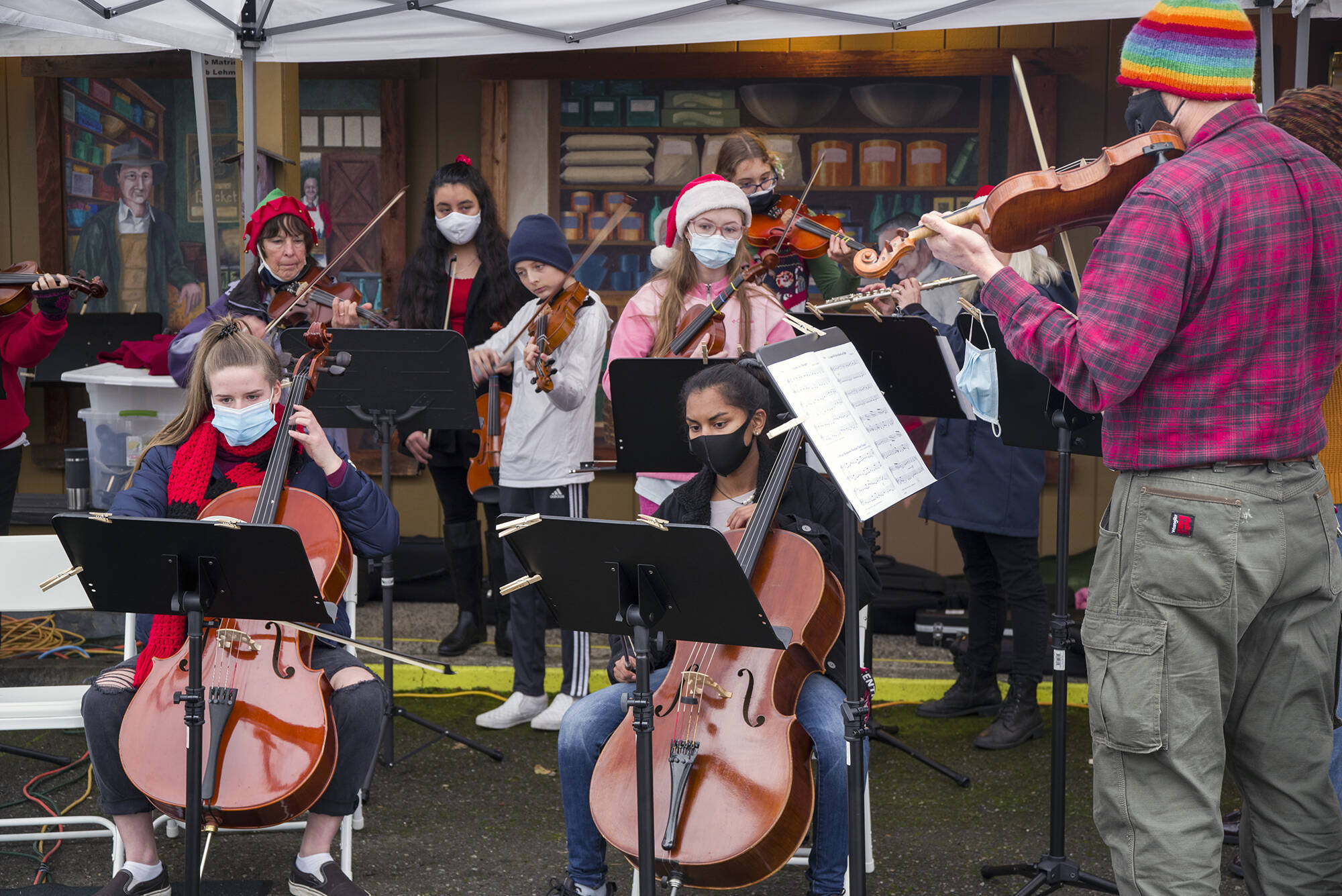 Sequim Gazette file photo by Emily Matthiessen
Members of Sequim Community Orchestra, with youth from their strings program, play holiday favorites at the Home Town Holidays event in Sequim in 2021.