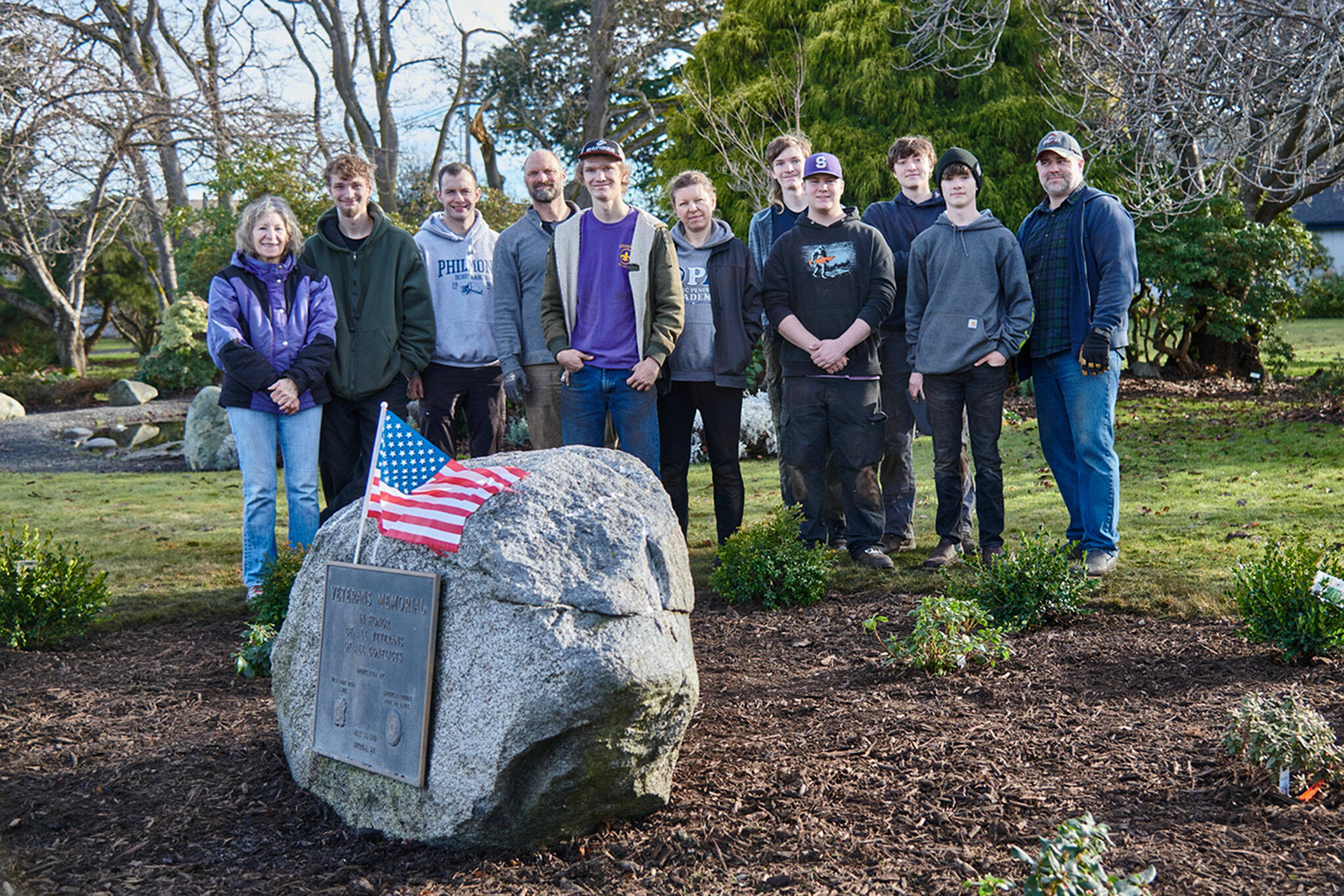Photo courtesy Dan Mannisto/ BSA Eagle Scout candidate Dean Rynearson, fifth from left, with Troop 90 worked with family, friends and fellow scouts to revamp the Veterans Memorial at Sequim Pioneer Memorial Garden along East Washington Street on Jan. 14.