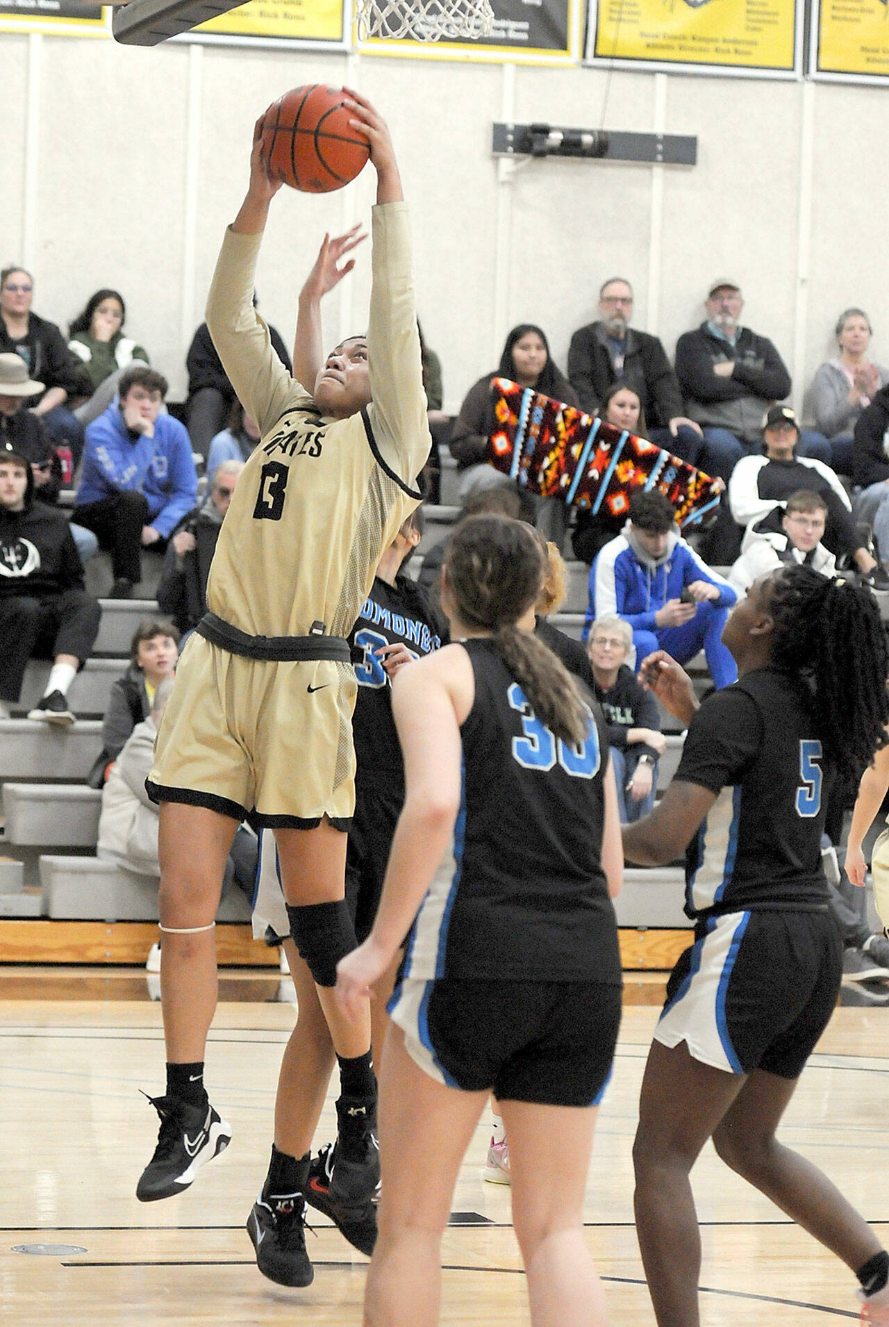 Photo by Keith Thorpe/Olympic Peninsula News Group / Peninsula’s Ituau Tuisaula reaches for the hoop as Edmonds defenders, from left, Leilani Motta, Aspen Carter and Danielle Woods look on during a Jan. 28 game in Port Angeles.