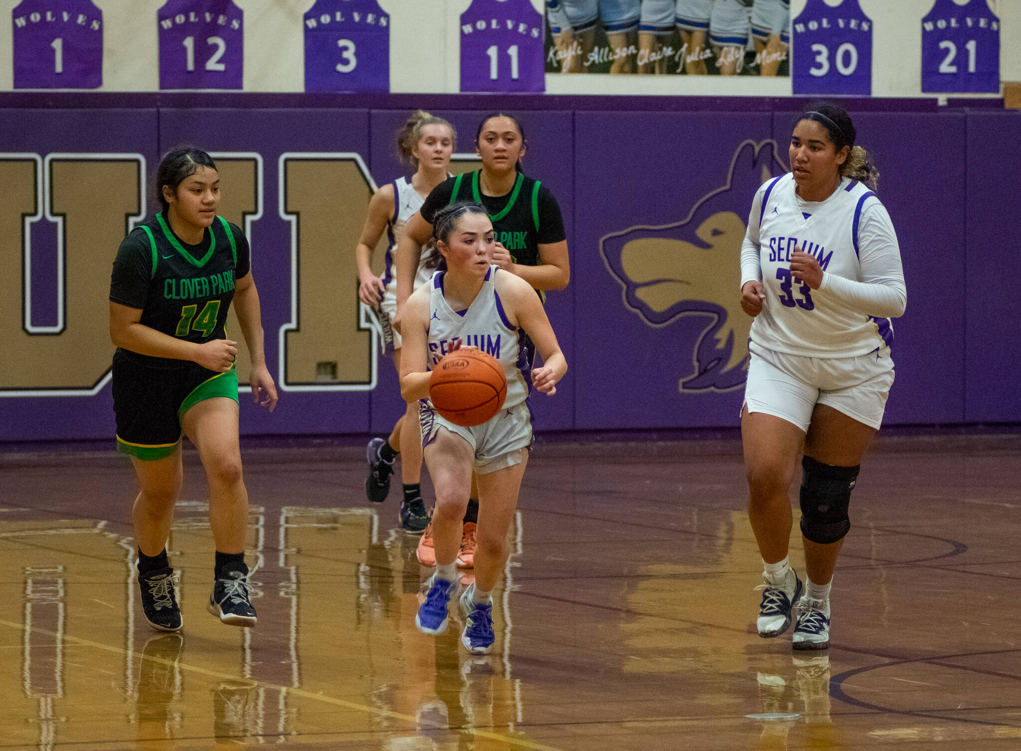 Sequim Gazette photo by Emily Matthiessen / Sequim guard Hannah Bates, center, and teammate Jelissa Julmist go on the offensive as Clover Park’s Marlene Iafeta pursues, in the Wolves’ 65-29 district tourney-opening win at home on Feb. 14. Bates led the team with 15 points and Julmist added 13.