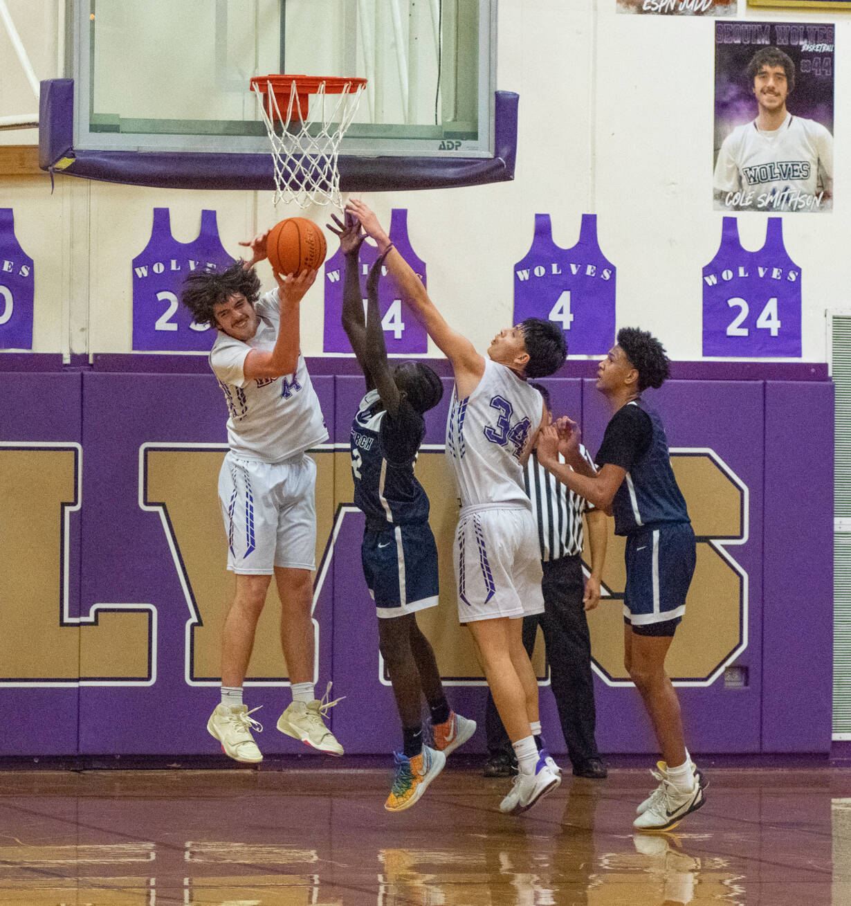 Sequim Gazette photo by Emily Matthiessen / Sequim’s Cole Smithson, left, snags a rebound with help from teammate Isaiah Moore in the Wolves’ 66-37 West Central District tourney playoff win over visiting Lindbergh on Feb. 15.