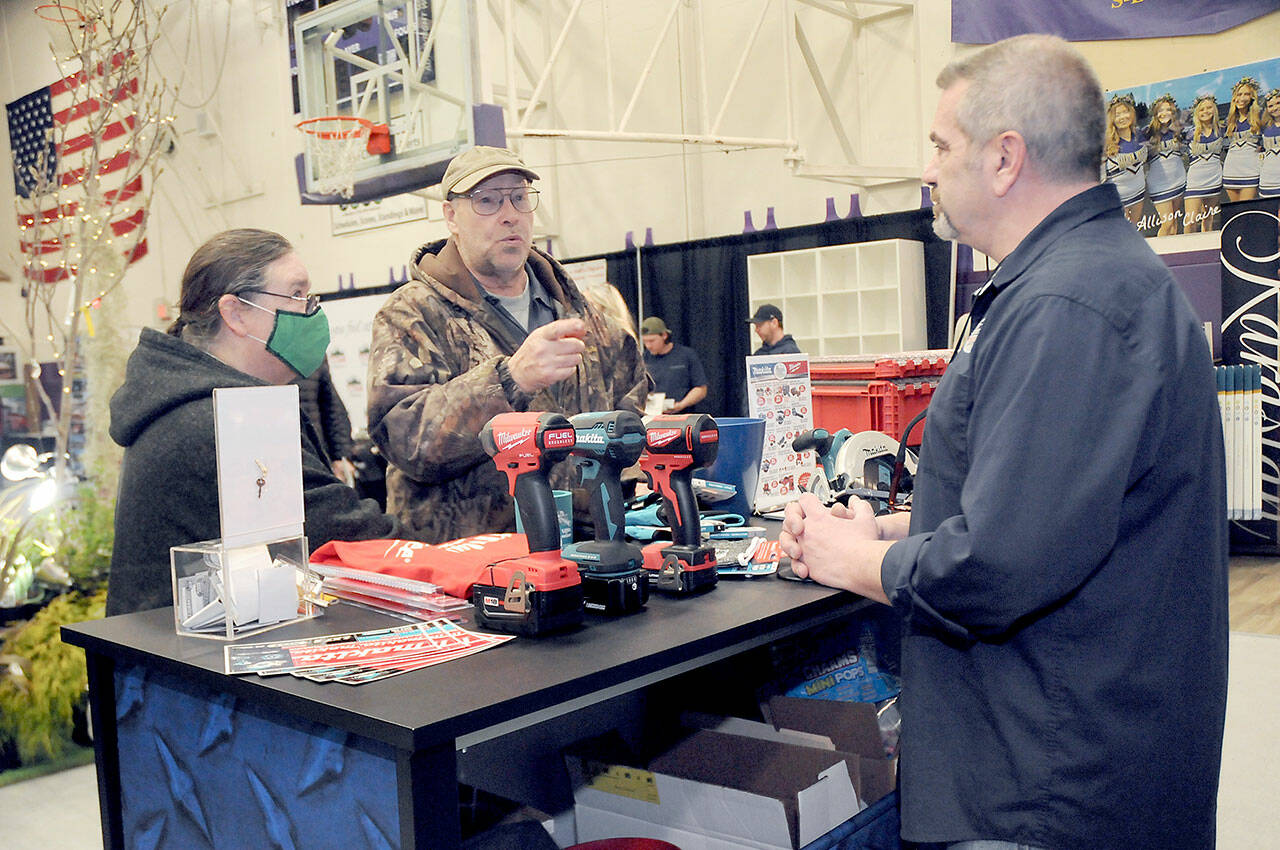 Photo by Keith Thorpe/Olympic Peninsula News Group
Jack and Marcella Ridge of Sequim talk about power tools with Tony Contestable, tool specialist with Hartnagel Building Supply of Port Angeles, right, during the 2023 Building, Remodeling & Energy Expo in the Sequim High School gym on Feb. 18. The two-day event, hosted by the North Peninsula Building Association, featured a variety of booths, displays and presentations dedicated to home building, repair and remodeling.