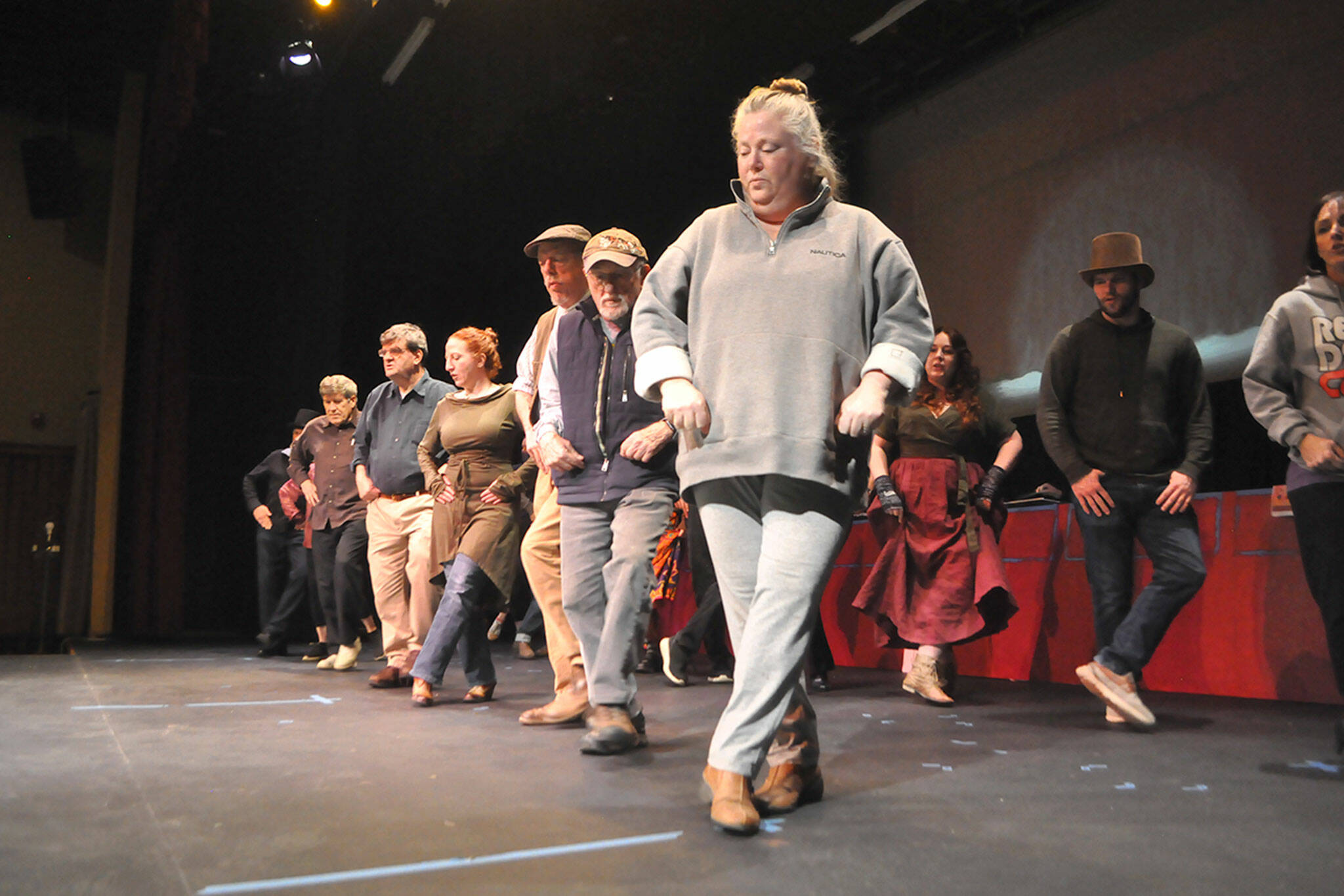 Sequim Gazette photo by Matthew Nash/ Beth McHugh as Princess Puffer, front, practices a dance number with other cast members in “The Mystery of Edwin Drood” at Olympic Theatre Arts running March 10-26. The musical comedy invites audience members’ participation to vote on the murderer, and more.