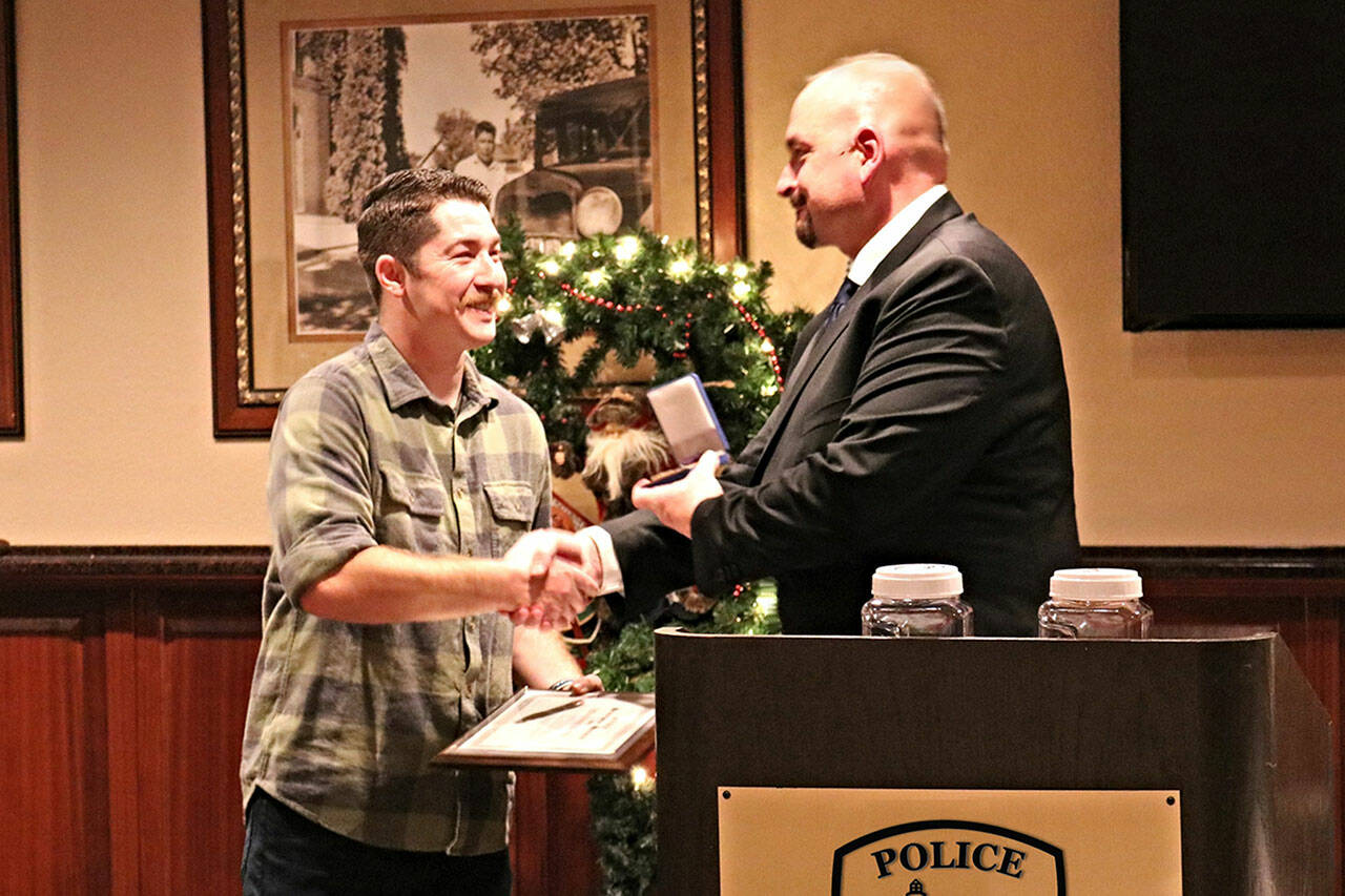Photo courtesy Sequim Police Department
Officer Daniel Martinez, left, receives a Purple Heart at a Sequim Police Department awards dinner in December 2022 from Sgt. Dave Campbell for his actions in stopping a man who is accused of attempting to kill him during a traffic stop.