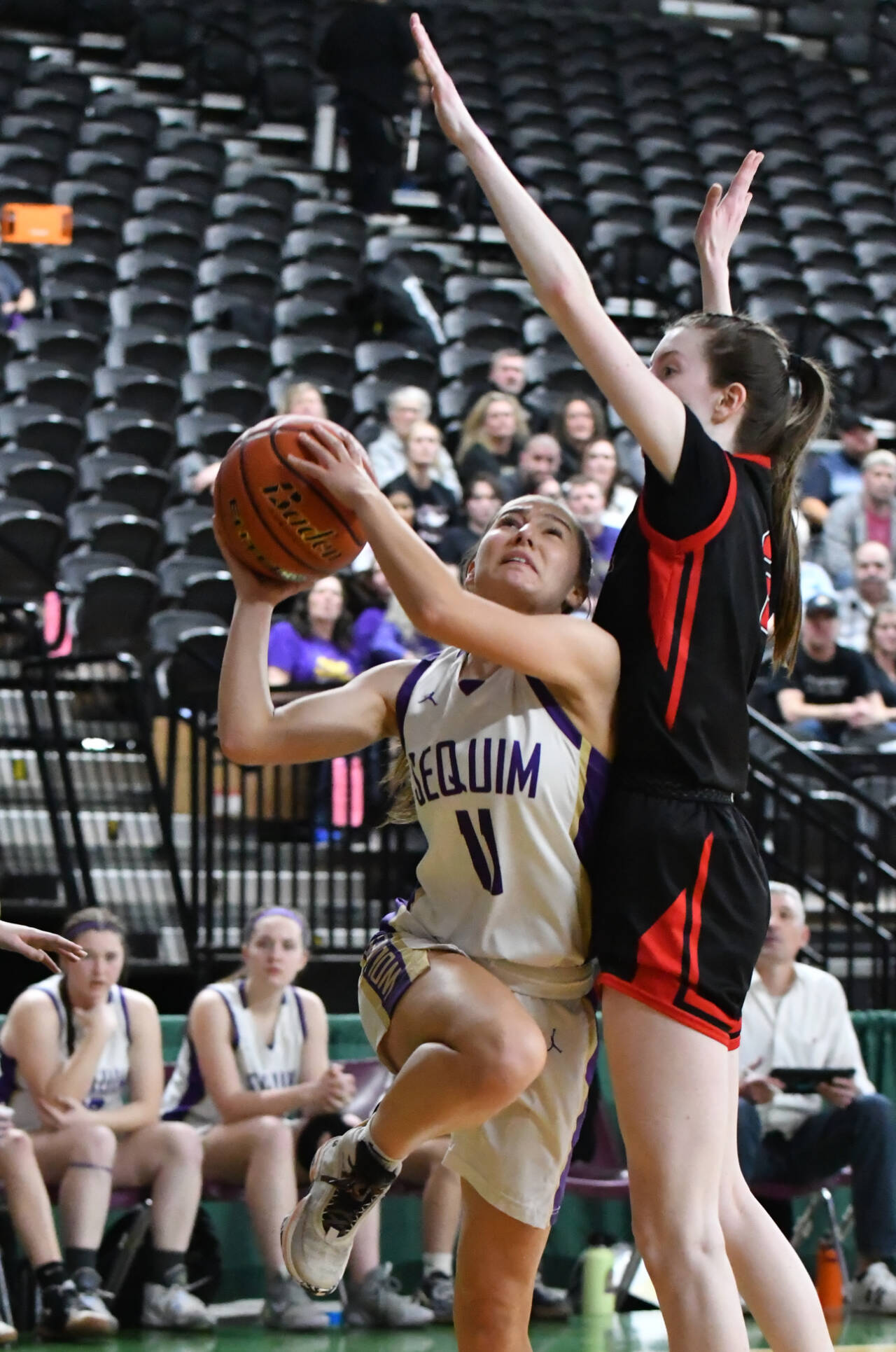 Photo by Jim Heintz / Sequim guard Taryn Johnson, left, drives to the basket in the second half of the Wolves’ 57-37 win over Sammamish in the class 2A state tournament in Yakima on March 1.