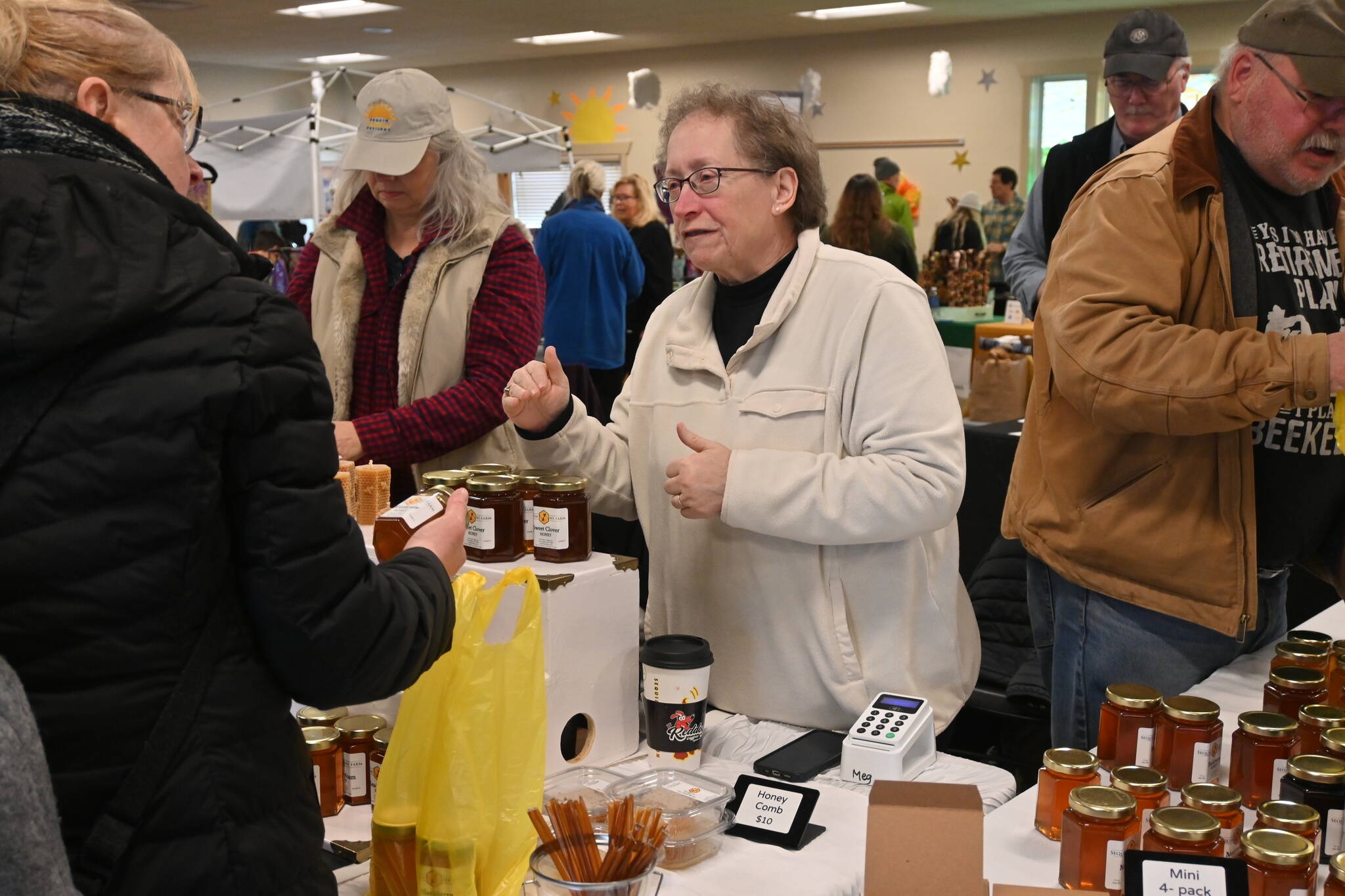 Sequim Gazette photo by Michael Dashiell / Meg and Buddy Depew chat with customers at the Sunshine Market inside the Guy Cole Event Center on March 4.