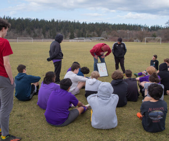 Sequim Gazette photo by Emily Matthiessen / From left, junior varsity coach Dave Breckenridge, and assistant coaches Jared King and Javier Gomez lay out a practice plan for the junior varsity soccer team.