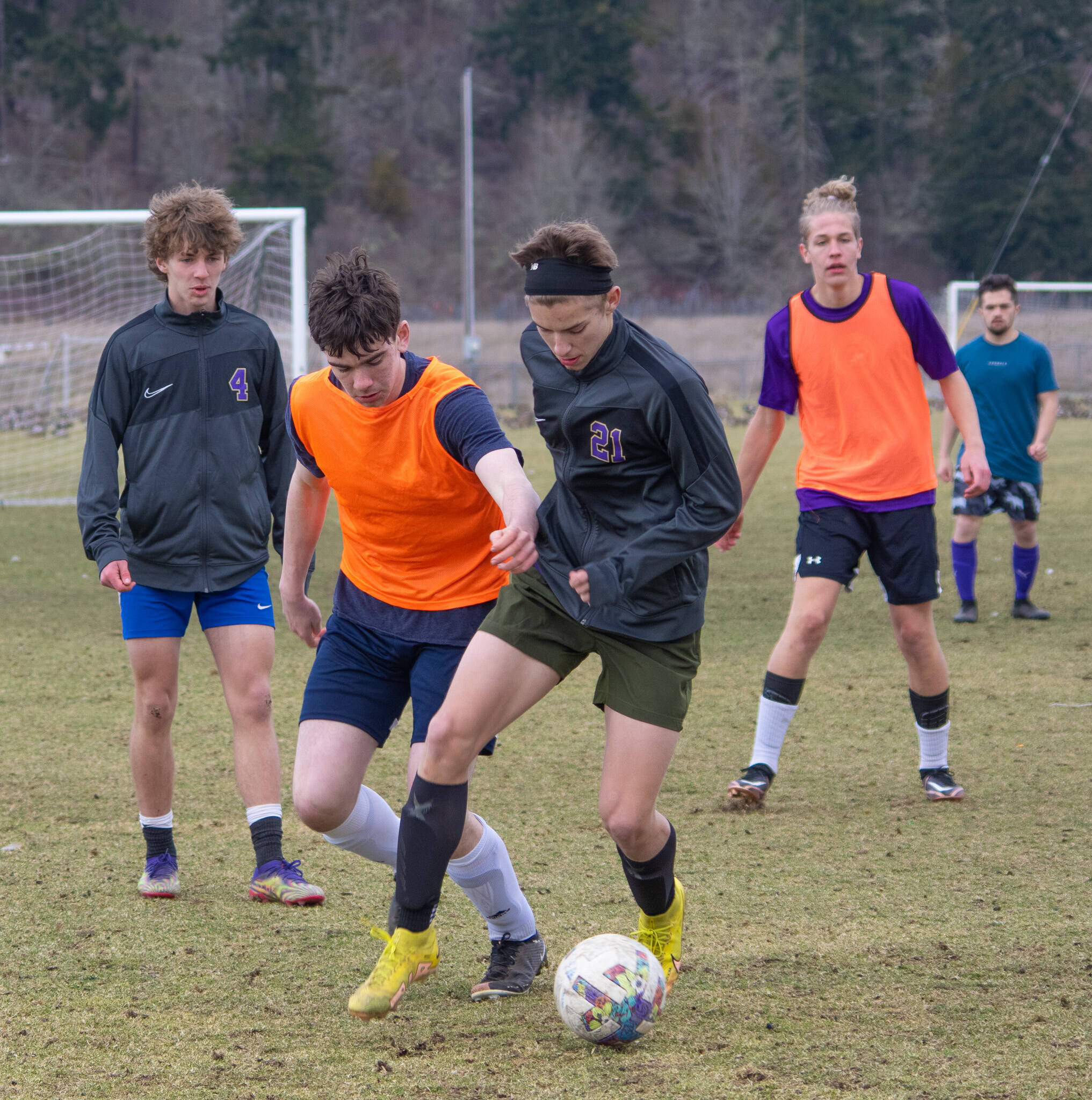 Sequim Gazette photo by Emily Matthiessen / Preston Kurtze holds the ball with Colin Feik immediately behind, as the varsity soccer team practices at the Albert Haller Playfields at Carrie Blake Community Park.