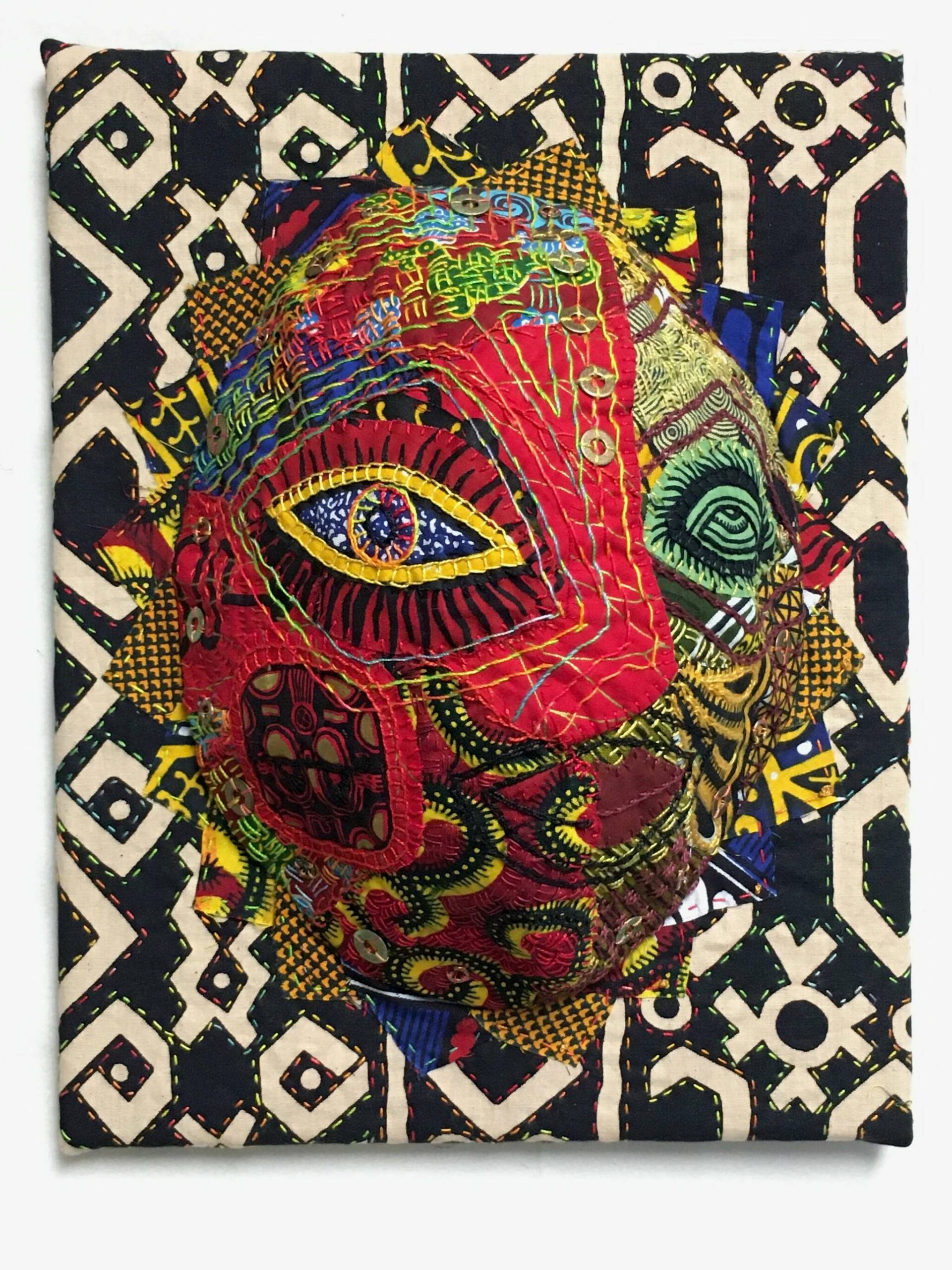 Submitted photo / “Paris Eyes Kinshasa” by Sequim artist Liisa Fagerlund, whose fabric collage is featured along with a number of other pieces in the “Masks: Second Skins” exhibit by the Peninsula Fiber Artists in Port Townsend.