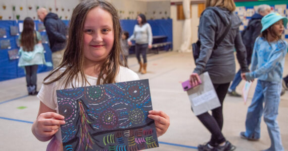 Sequim Gazette photo by Emily Matthiessen / Katelyn Williams, fourth grade student, shares her replication of Van Gogh’s “Starry Night” at Greywolf Elementary’s “Meet the Masters Art Show.” She said, “I’m really proud of it because it shows I how I like ‘Meet the Masters’.” She added that she made another one at home.