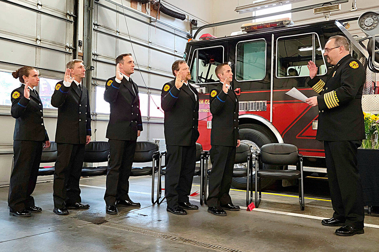 Photo courtesy Clallam County Fire District 3/ Fire chief Ben Andrews with Clallam County Fire District 3, far right, swears in probationary firefighters/paramedics, from left, Eliza Winne, Erik Payne, Bryant Kroh, Mark Karjalainen, and Jeremy Church on March 20 in Station 34 for a badge pinning ceremony.