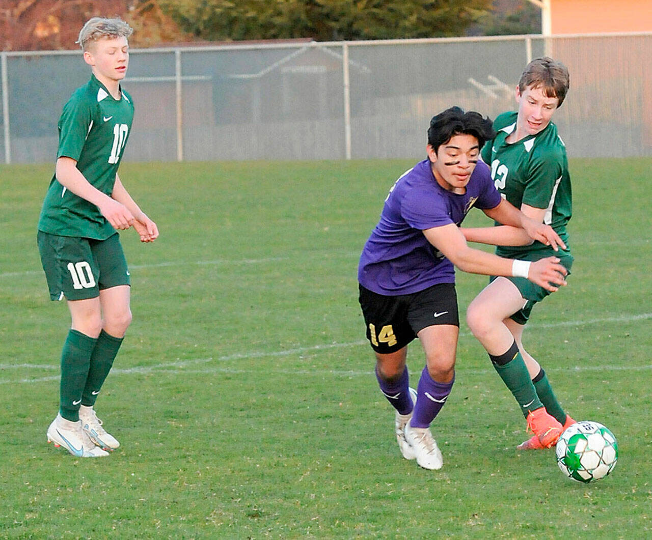 Photo by Keith Thorpe, Olympic Peninsula News Group/ Sequim’s Evan Cisneros, center, pushes past Port Angeles’ Jacob Weaver, right, as Weaver’s teammate, Matthew Miller, looks on at left on March 16 in Port Angeles.
