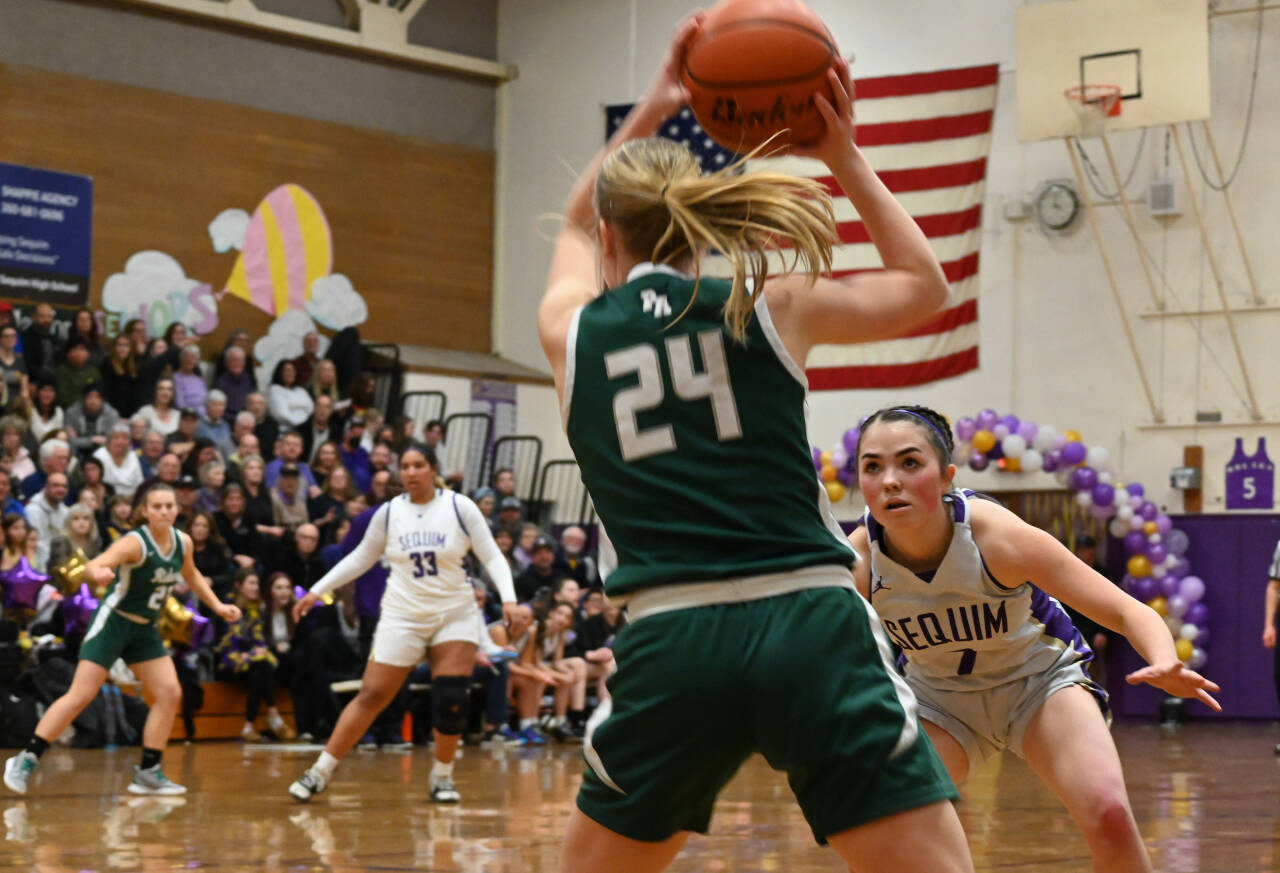 Sequim Gazette file photo by Michael Dashiell / With teammate Jelissa Julmist near mid-court, Sequim’s Hannah Bates, right, keeps a close eye on Port Angeles guard Anna Petty in the first half of the Wolves’ 57-46 win on Feb. 2. Bates and Julmist joined Petty on the Cascade team at the 21st annual West Sound Senior High School All-Star Basketball contest in Bremerton High School in mid-March.