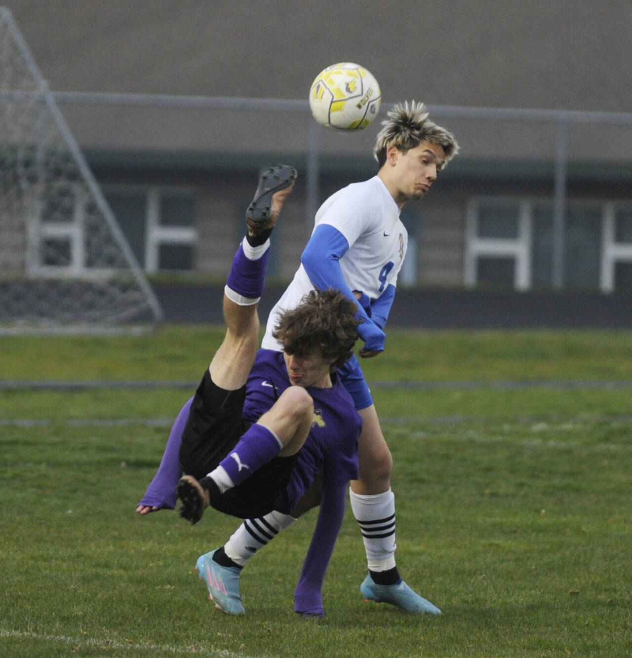 Sequim Gazette photo by Michael Dashiell / Sequim’s Lake Barrett launches a bicycle kick over Bremerton’s Evan Harvey in a March 30 Olympic League match-up.