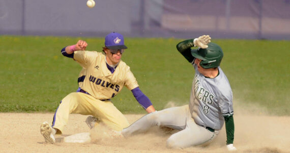 Michael Dashiell/Olympic Peninsula News Group
Sequim's Bryan Laboy, left, looks to put the tag on Port Angeles' Colton Romero in the third inning of an Olympic League match-up on April 13. The Roughriders scored five innings en route to a 12-2 win in Sequim.