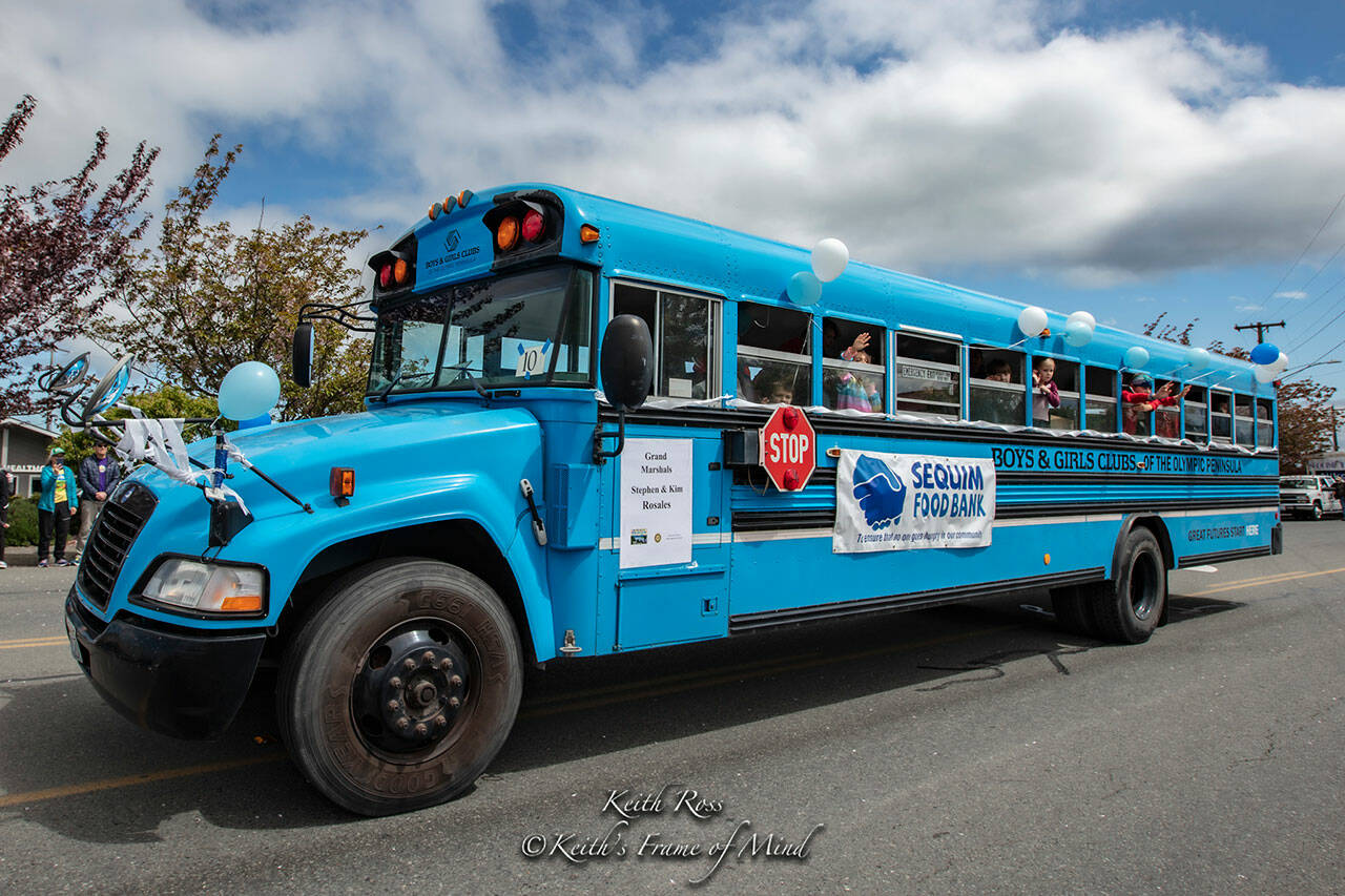 Photo courtesy Keith Ross/ Keith’s Frame of Mind/ The Boys & Girls Clubs of the Olympic Peninsula’s bus rides down the Sequim Irrigation Festival Grand Parade. Volunteer driver Stephen Rosales sought $16,000 to help offset repair costs to the bus that transports more than 50 students daily to the club from Greywolf Elementary. Community donors helped cover the expenses in recent weeks.