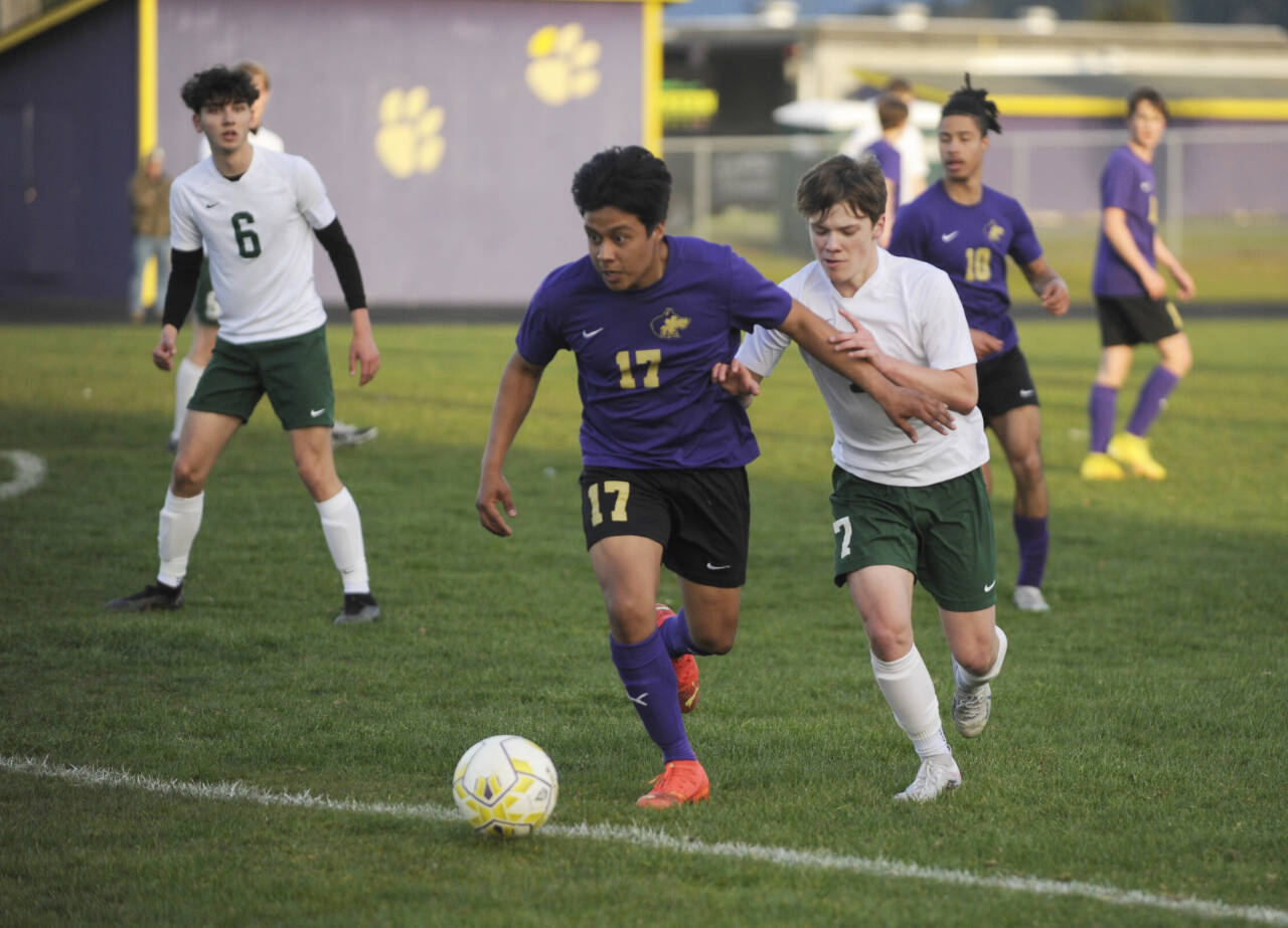 Sequim’s Abe Torres (17) and Port Angeles’ Kaleb Gagnon (7) vie for the ball in the first half of an April 18 Olympic League match-up in Sequim. The host Wolves got a first half goal and held on for a 1-0 victory.