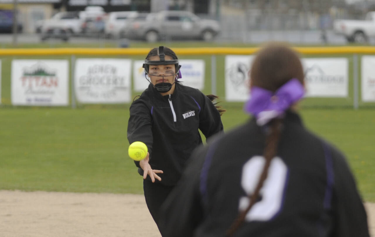Sequim Gazette photo by Michael Dashiell / Sequim second baseman Taylee Rome, left, tosses the ball to teammate Sammie Bacon for a key out in the Wolves’7-6 win over rival port Angeles on April 18.