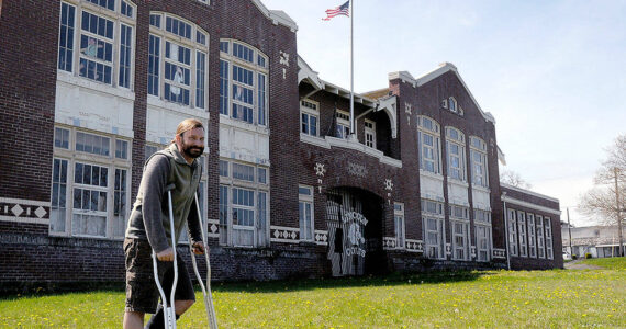 David Brownell, executive director of the North Olympic History Center, stands in front of the historic Lincoln School at Eighth and C streets in Port Angeles on Tuesday. The NOHC is hoping to divest itself of the school building and has issued a request for proposal on what to do with the structure. (Keith Thorpe/Peninsula Daily News)