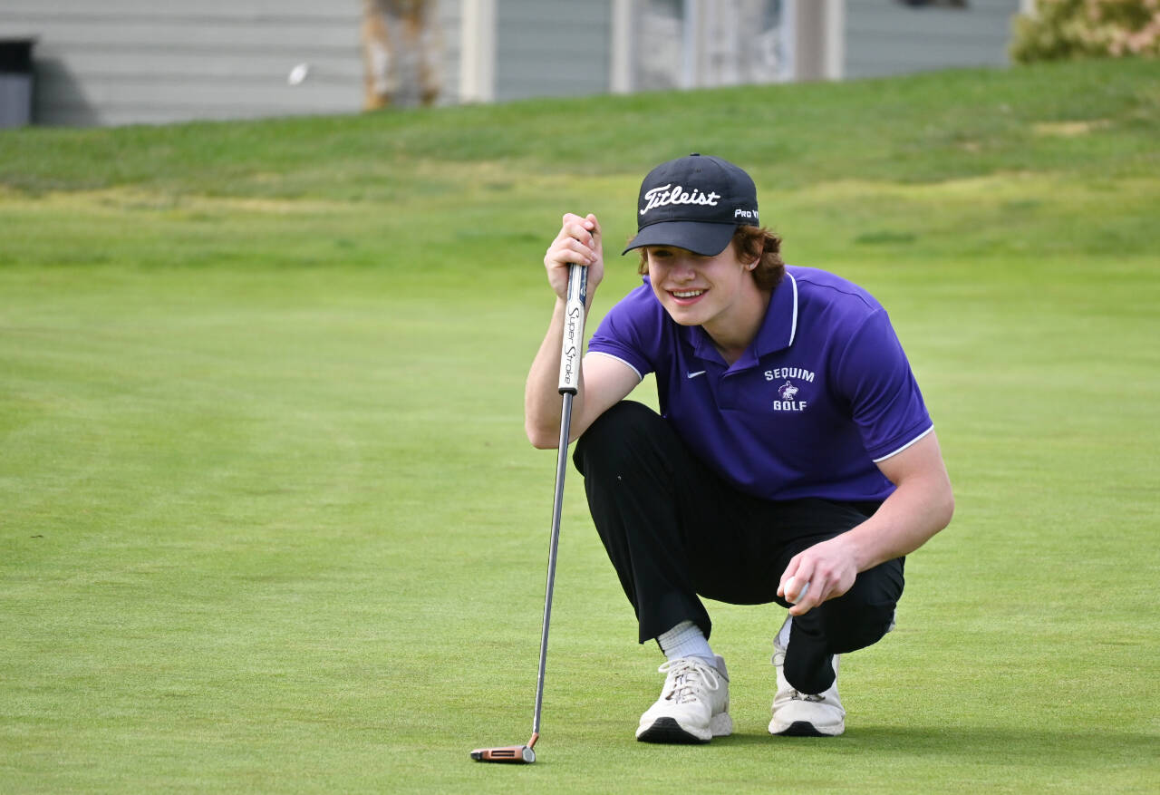 Sequim’s Carter Cronin lines up a putt on the fourth hole at The Cedars at Dungeness, in a league match against Olympic on April 26. Cronin was medalist for the match with a round of 40.