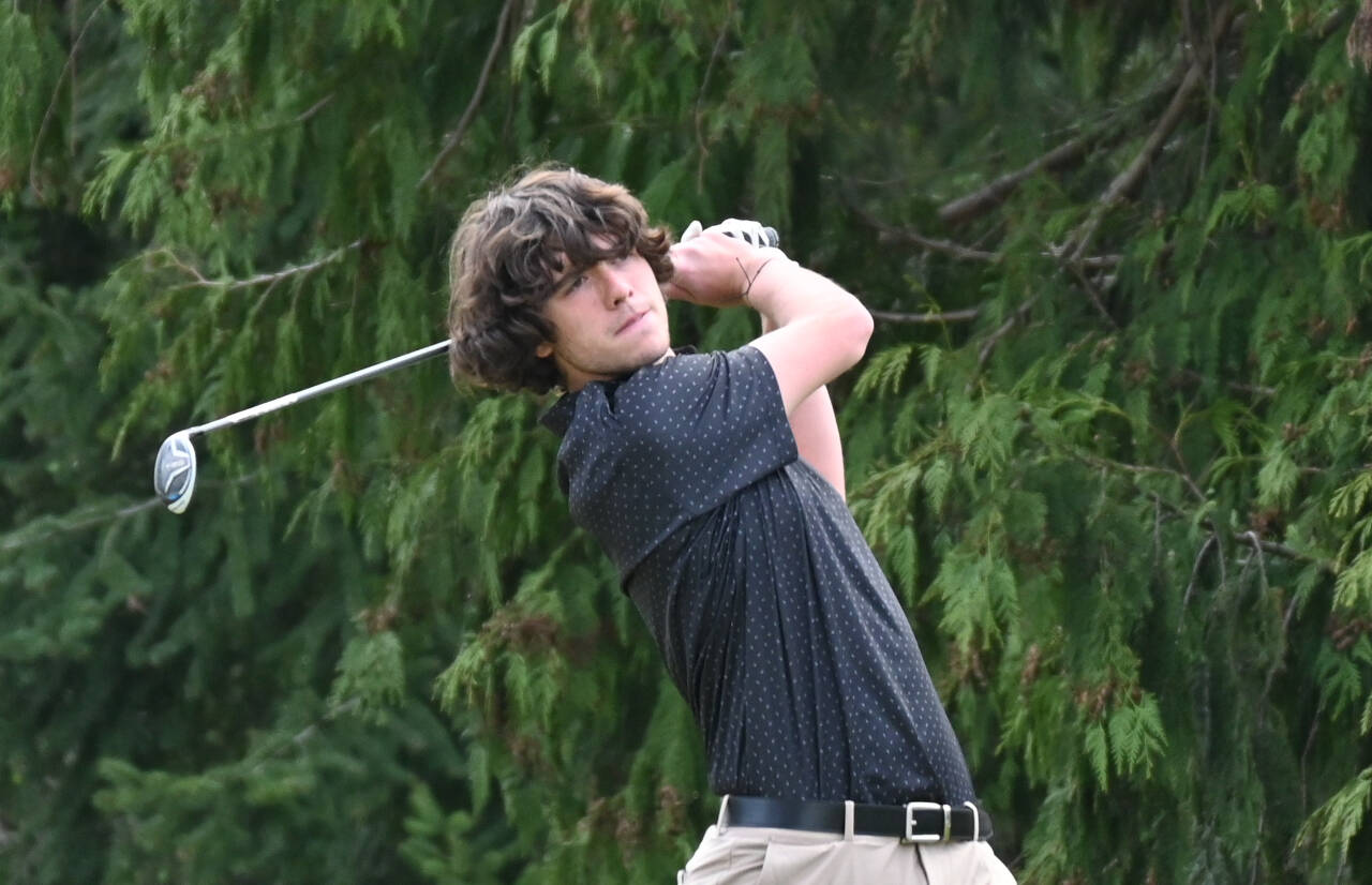 Sequim Gazette photo by Michael Dashiell / Sequim’s Cole Smithson watches a drive off the tee on the second hole at The Cedars at Dungeness on April 25, as the Wolves take on Olympic in a league match.