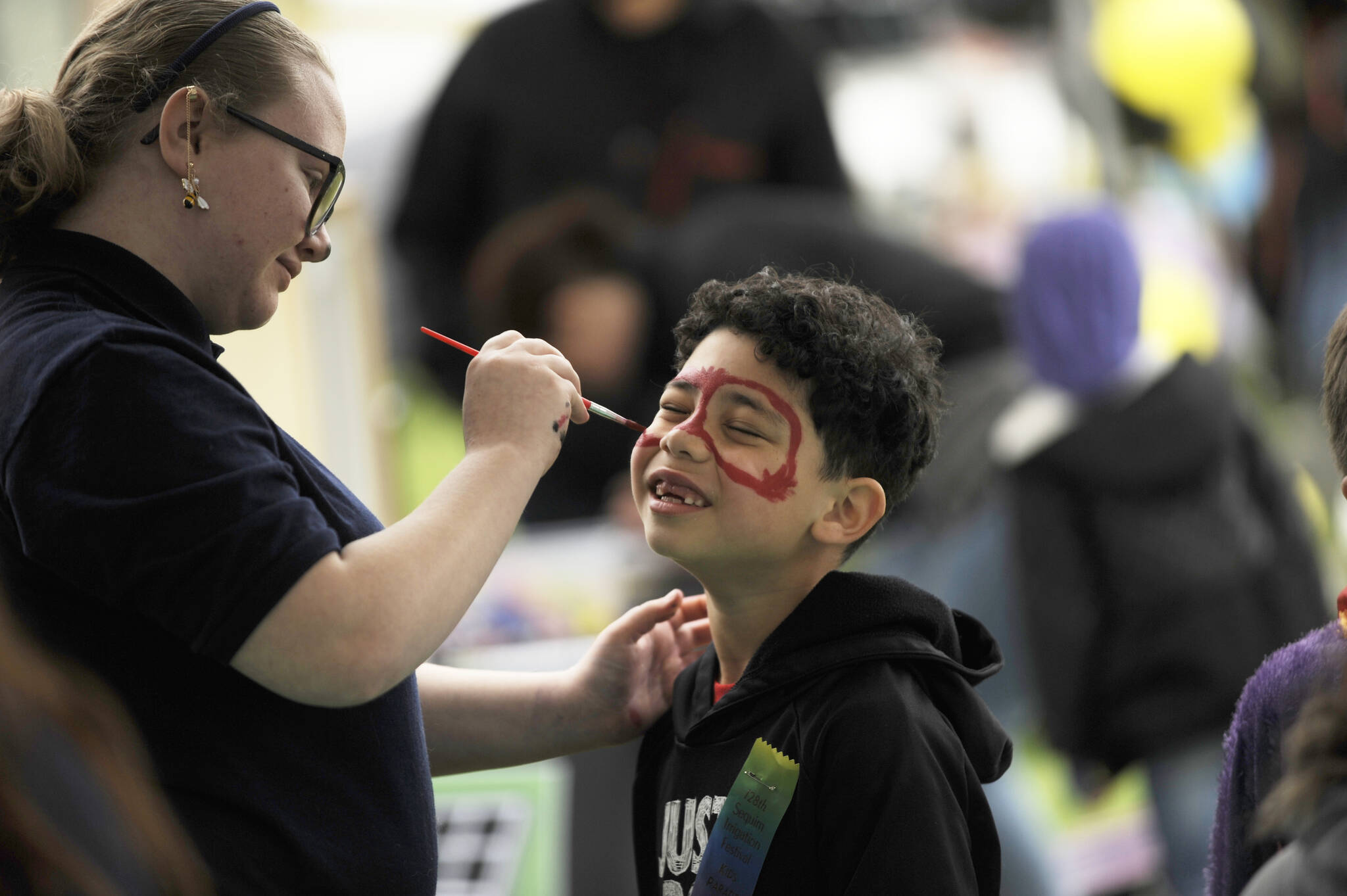Sequim Gazette photo by Michael Dashiell / Six-year-old Ezekiel Hicks of Sequim gets his face painted by high school junior Zinnia Barnes at the Sequim High FFA’s booth at the Family Fun Day event on May 6.