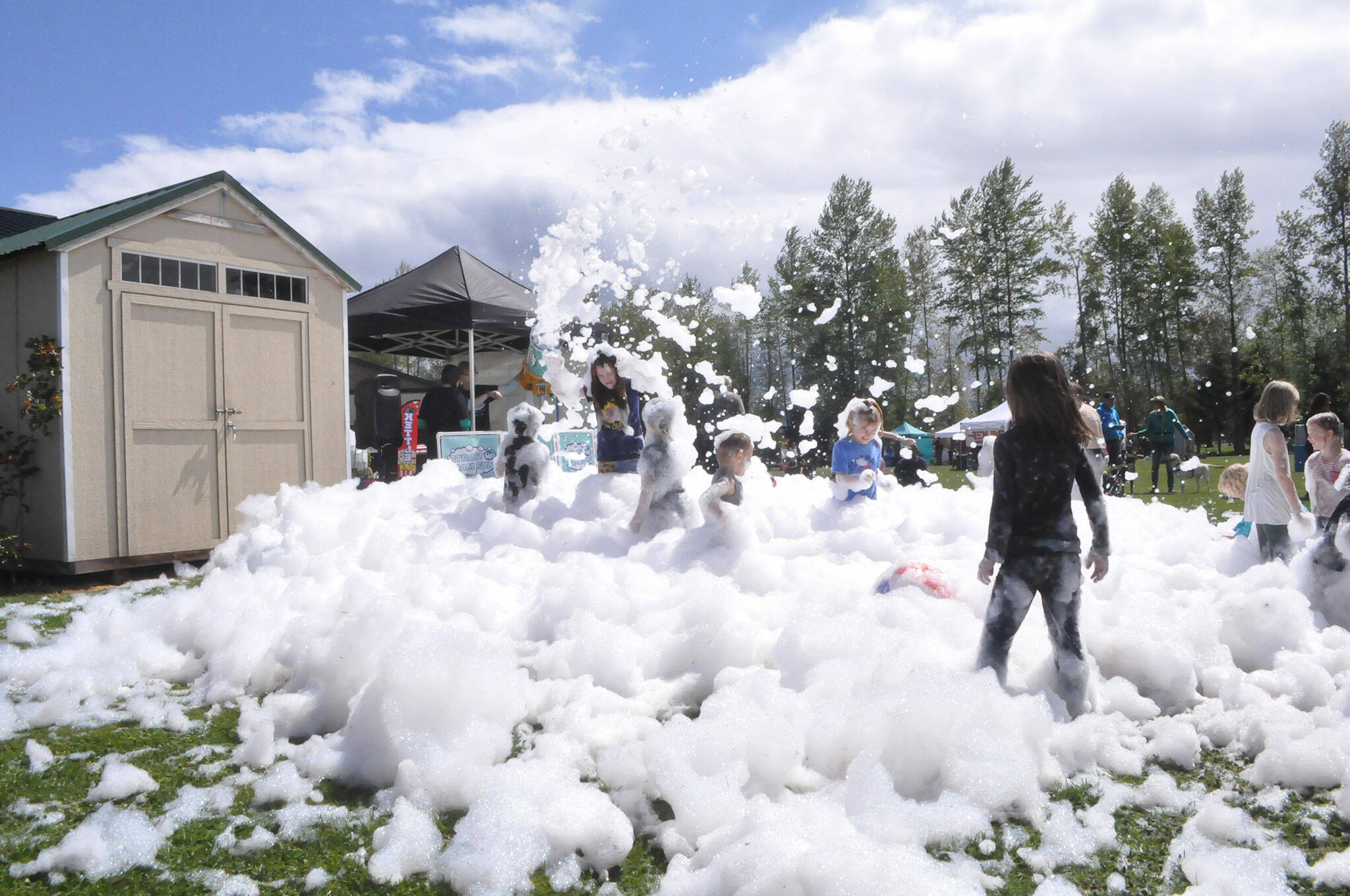 Sequim Gazette photo by Matthew Nash/ As part of Family Fun Days, Strait Up Foam Fun came to Carrie Blake Community Park on Sunday offering children and adults the chance to play in the eco-friendly, biodegradable foam for hours.
