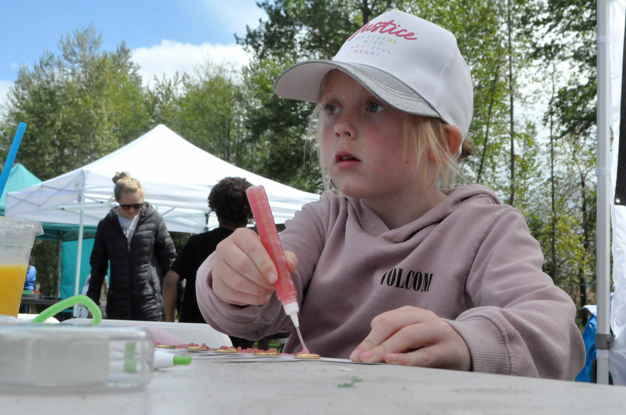 Sequim Gazette photo by Matthew Nash/ Vivienne Kautzman, 7, of Sequim makes a crown in the Irrigation Festival’s booth during Family Fun Days in Carrie Blake Community Park. Vivienne said she’s more into warriors than princesses but does like some princess stuff.