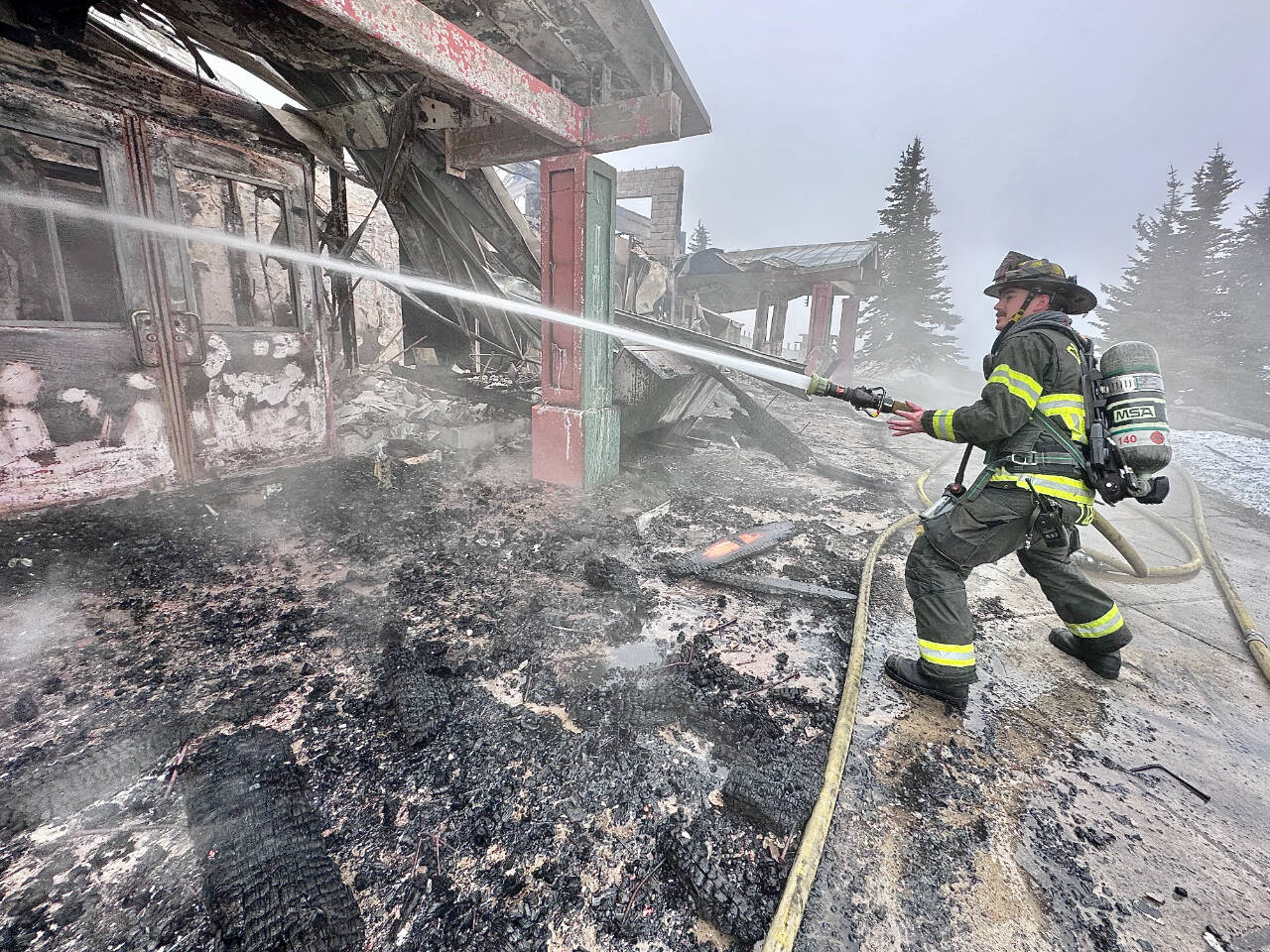 Photo by Jay Cline/Clallam County Fire District 2 / Firefighters from Clallam 2 Fire-Rescue and the Port Angeles Fire Department tend to a fire at the Olympic National Park Day Lodge on May 7.