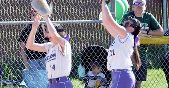 Photo by Keith Thorpe/Olympic Peninsula News Group / Sequim’s Ava Ritter, left, and Hannah Bates both reach for a pop fly against Port Angeles — with Bates eventually making the catch — in an Olympic League match-up in Port Angeles on May 12.