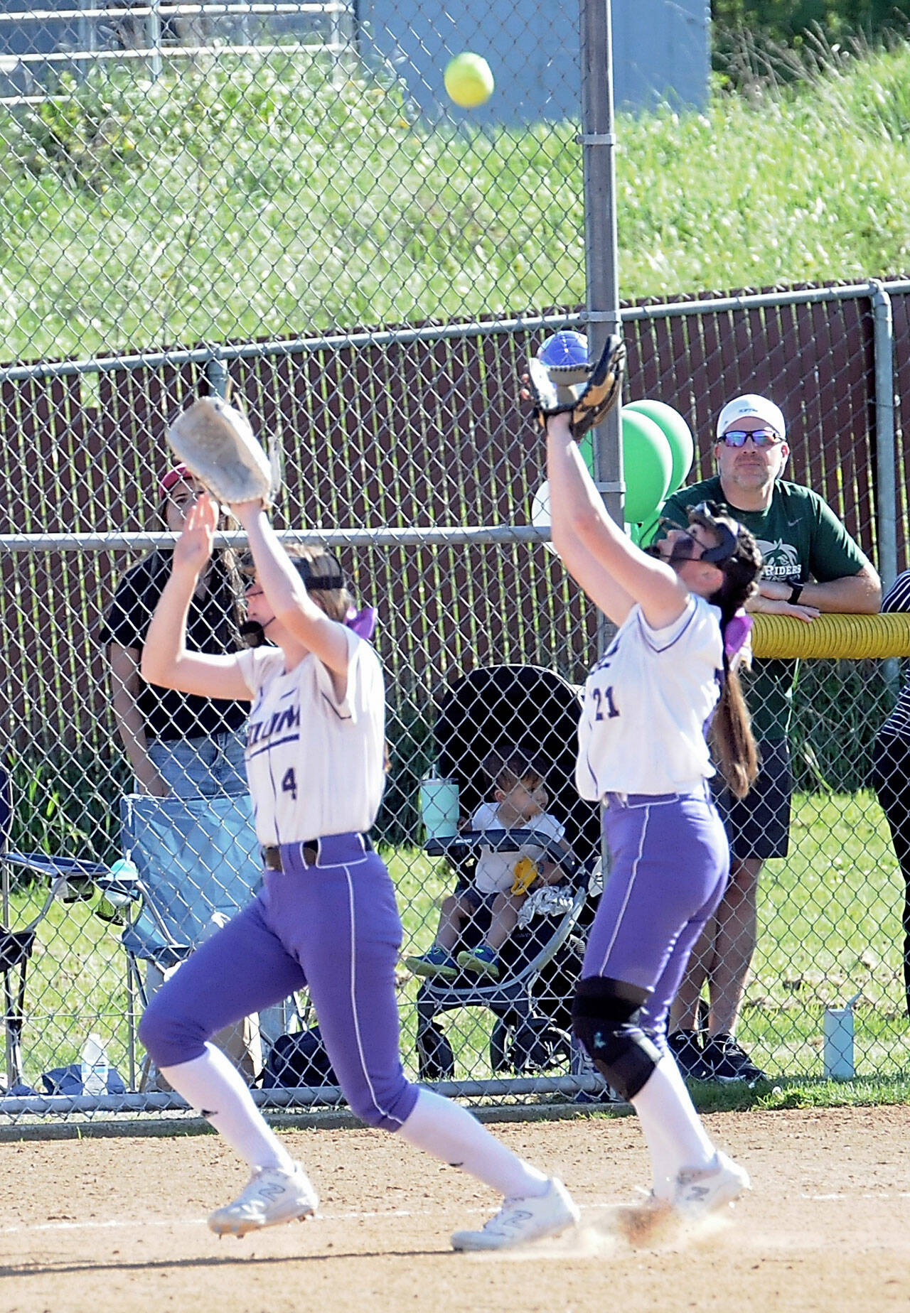 Photo by Keith Thorpe/Olympic Peninsula News Group / Sequim’s Ava Ritter, left, and Hannah Bates both reach for a pop fly against Port Angeles — with Bates eventually making the catch — in an Olympic League match-up in Port Angeles on May 12.