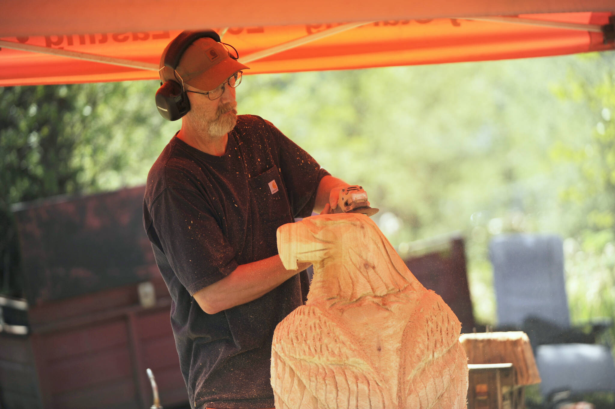 Sequim Gazette photo by Michael Dashiell 
Port Angeles sculptor Eric Berson of The Dreamer’s Wood works on a large eagle sculpture at the Sequim Irrigation Festival Logging Show on May 12.