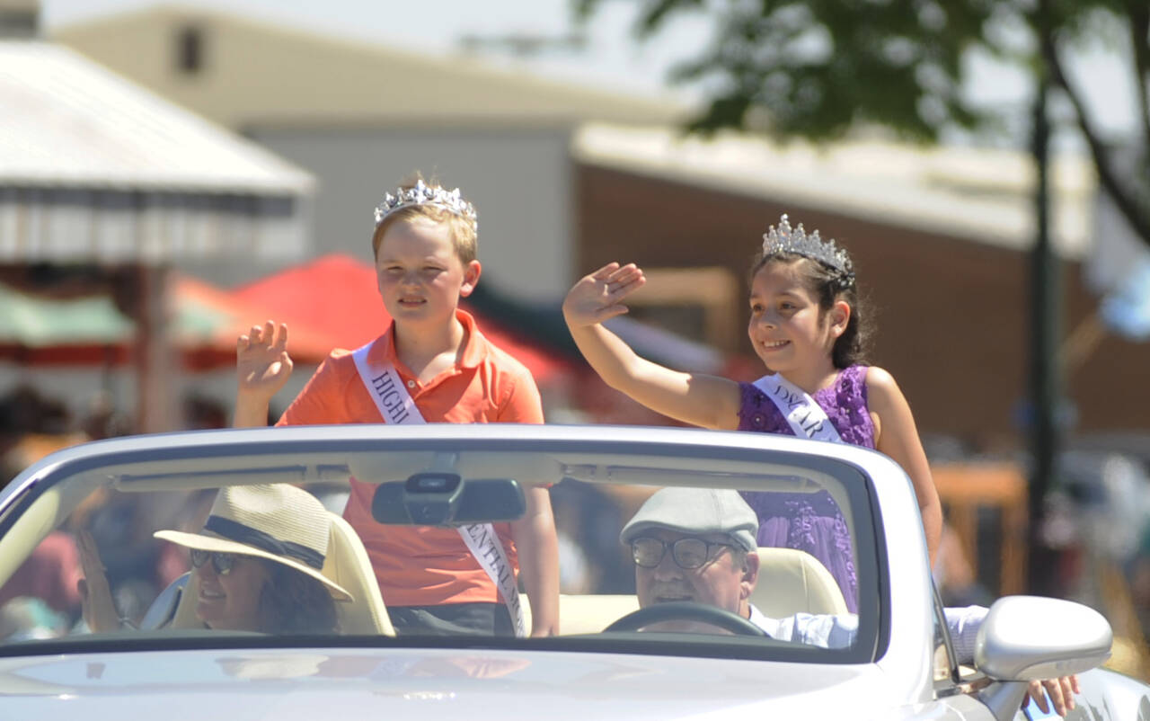 Sequim Gazette photo by Michael Dashiell / Junior Royalty Grayson Castell and Lynn Westman, of Helen Haller Elementary School, wave to the Sequim Irrigation Festival Grand Parade crowd on May 13.