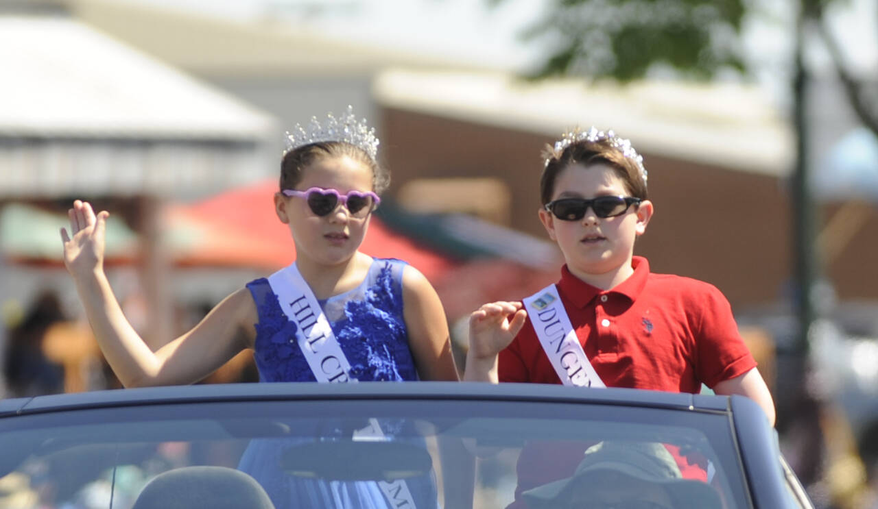 Sequim Gazette photo by Michael Dashiell / Junior Royalty Sophia Lopez and Greyson Rhodes, Of Greywolf Elementary School, wave to the Sequim Irrigation Festival Grand Parade crowd on May 13.