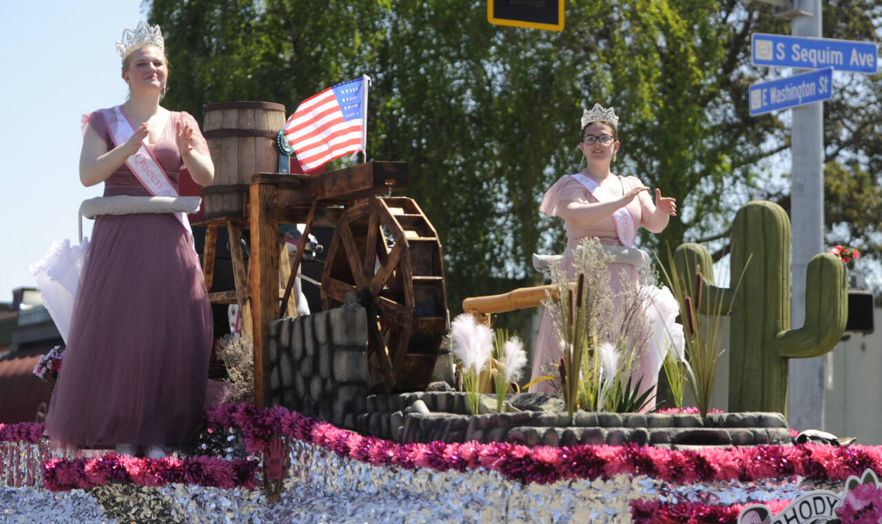 Sequim Gazette file photo by Michael Dashiell / Wild Wild Rhody Festival royalty Melody Douglas, left, and Paige Govia wave to the crowd at the Sequim Irrigation Festival Grand Parade on May 13. The float took home the President’s Award following the parade.
