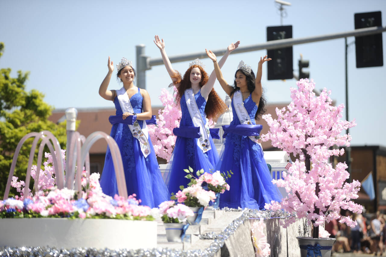 Sequim Gazette file photo by Michael Dashiell / Royalty from Capital Lakefair Festival wave to the crowd at the May 13 Sequim Irrigation Festival Grand Parade. The entry took the Judge’s Special award following the parade.