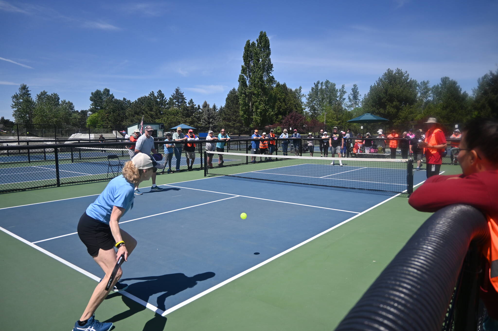 Sequim Gazette photos by Michael Dashiell
A crowd looks on as Abigail Berg returns a serve in a semifinal match in the Big Dill Fun Day tournament on May 20.