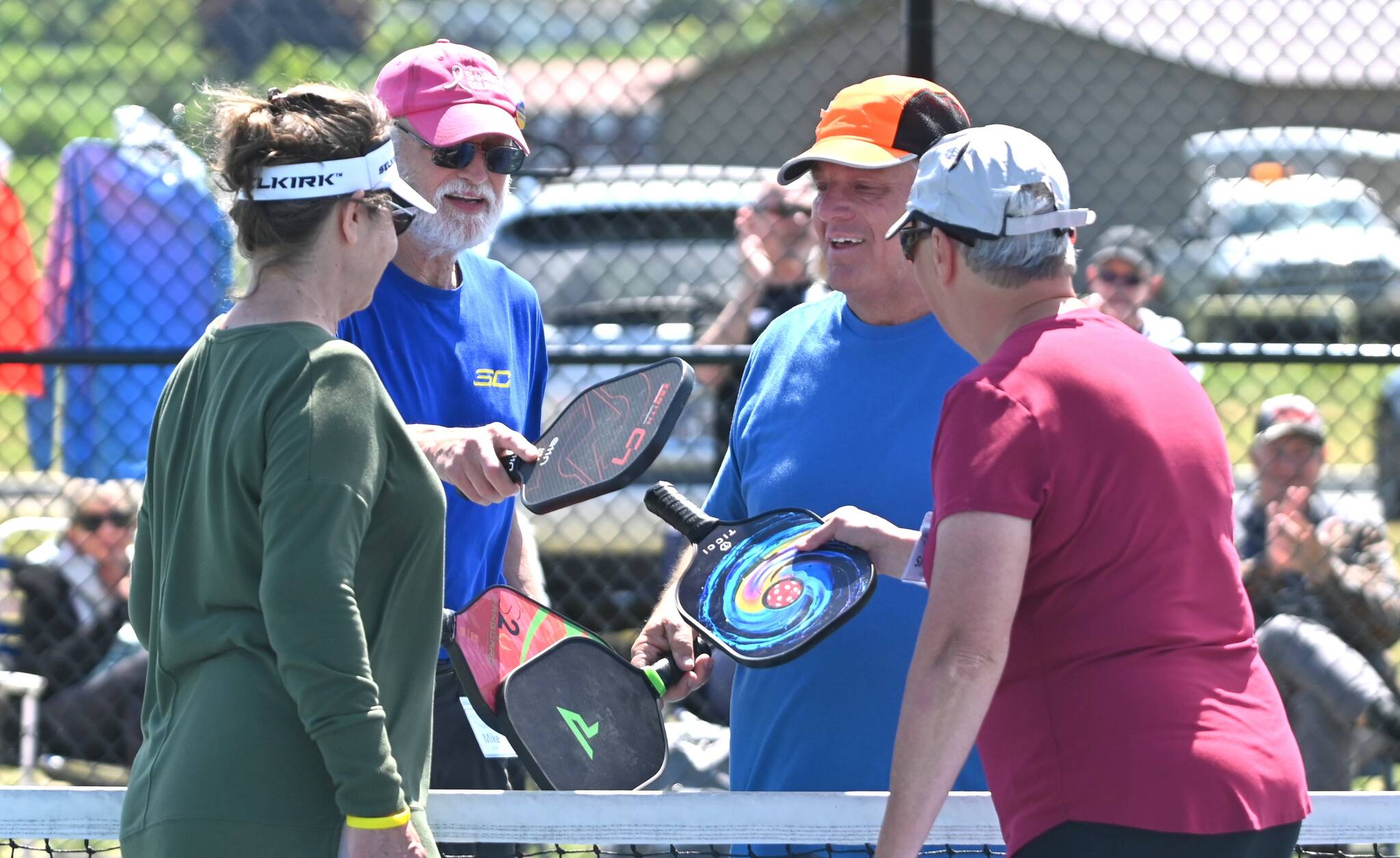 Sequim Gazette photo by Michael Dashiell / Mike Richer, left, and Kevin Jenks share post-match congrats with Cindi Pettit, far left, and Sherri Gyovai in the championship match at the Big Dill Fun Day tournament at Carrie Blake Community Park on May 20.